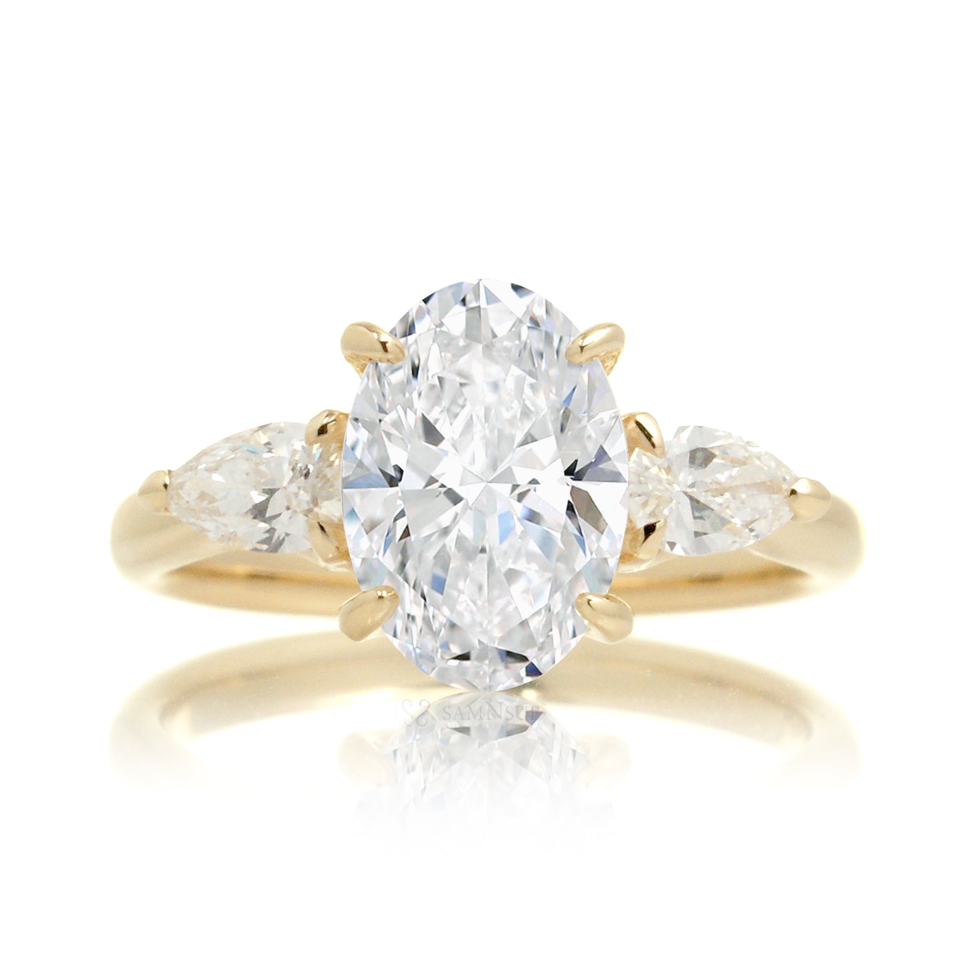 Classic three-stone oval cut diamond engagement ring yellow gold