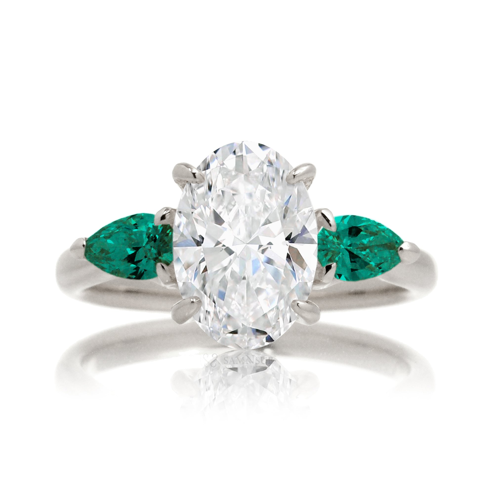 Three-stone pear emerald and oval cut diamond engagement ring white gold