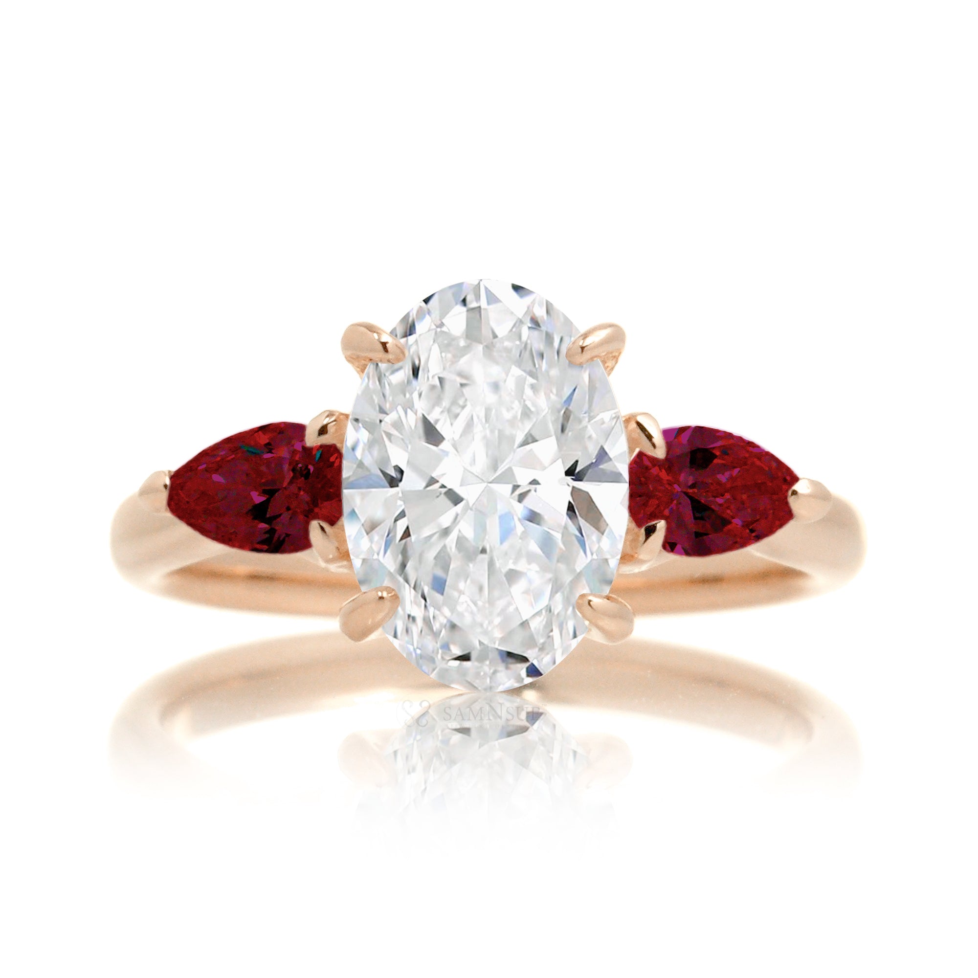 Three-stone pear ruby and oval cut diamond engagement ring rose gold