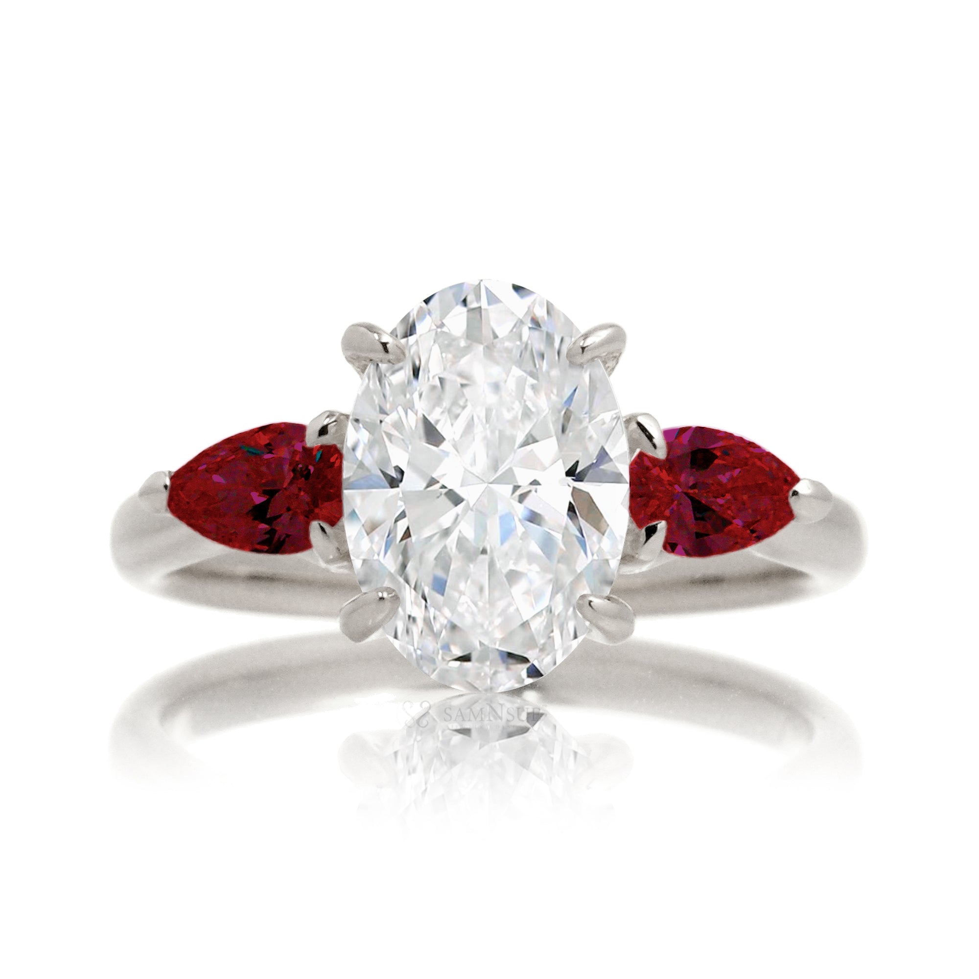 Three-stone pear ruby and oval cut diamond engagement ring white gold