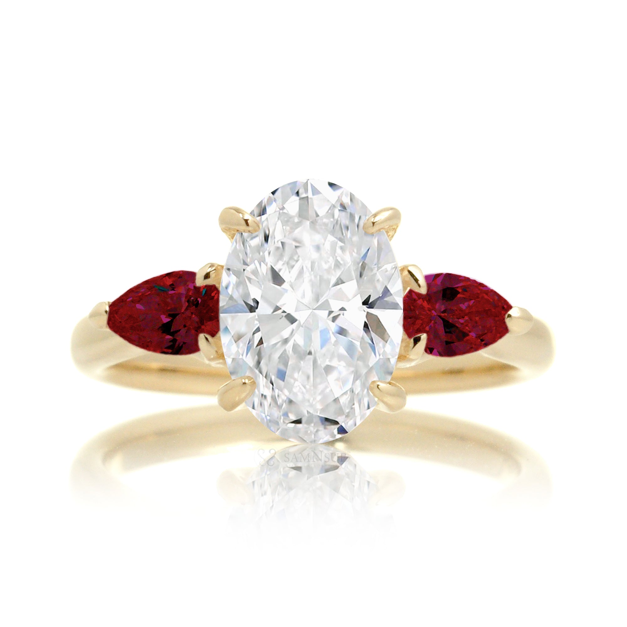 Three-stone pear ruby and oval cut diamond engagement ring yellow gold