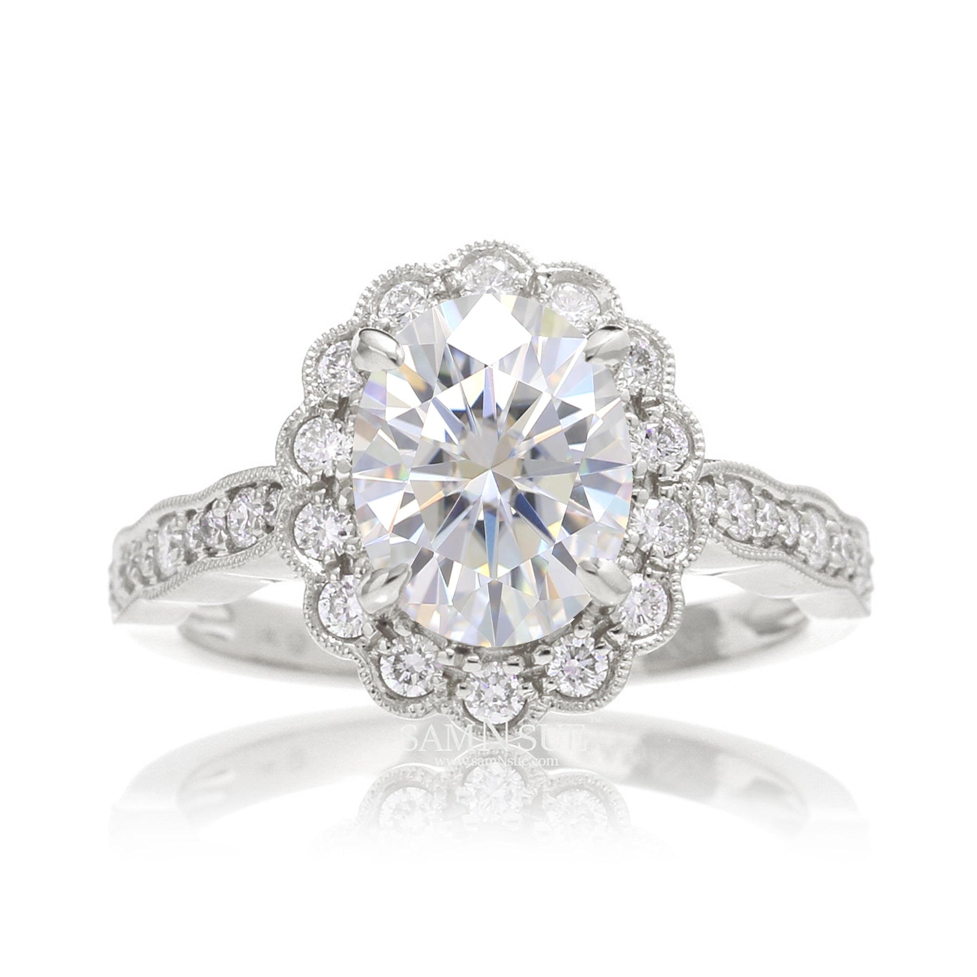 Oval moissanite engagement ring with scallop diamond halo and band with vintage filigree white gold