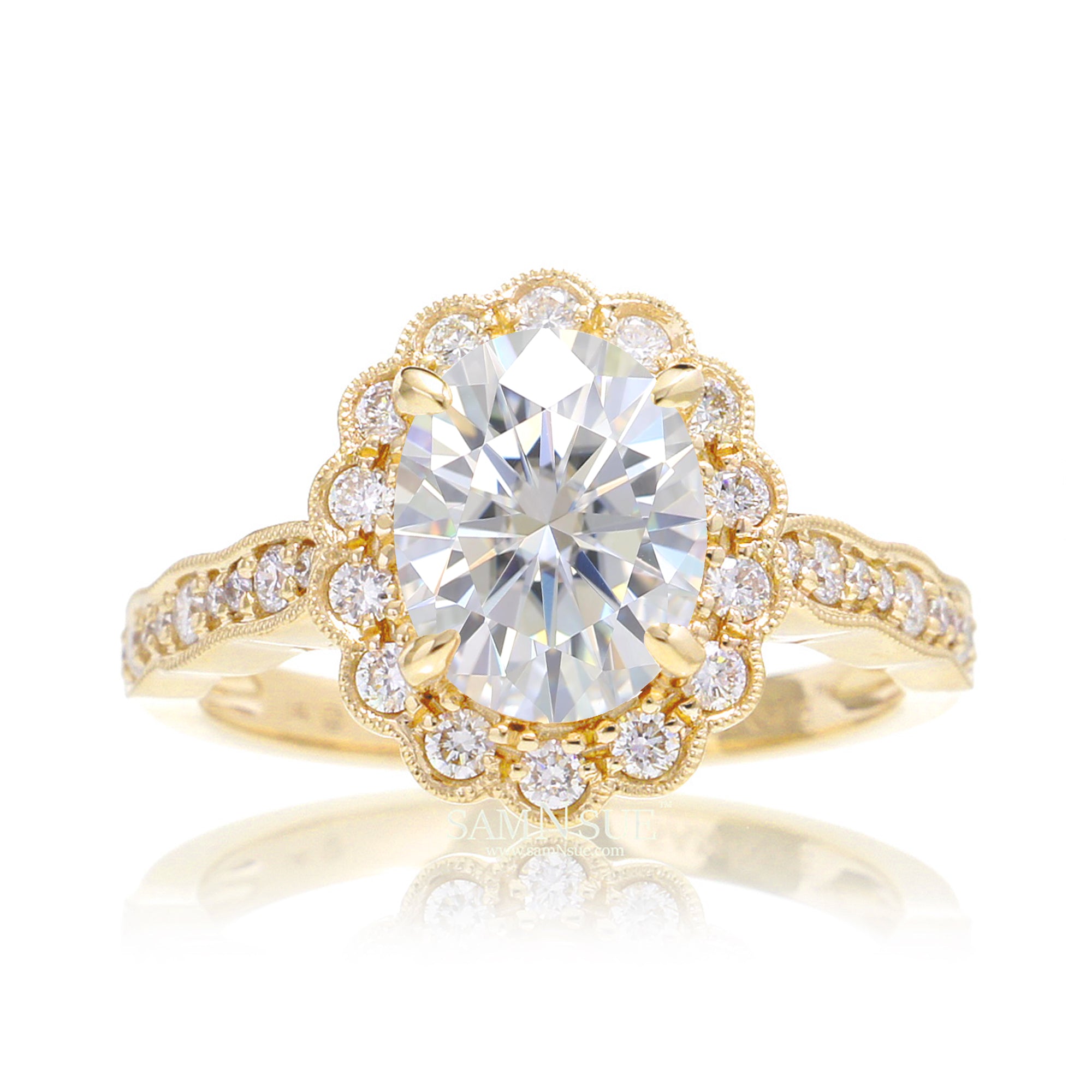 Oval moissanite engagement ring with scallop diamond halo and band with vintage filigree yellow gold