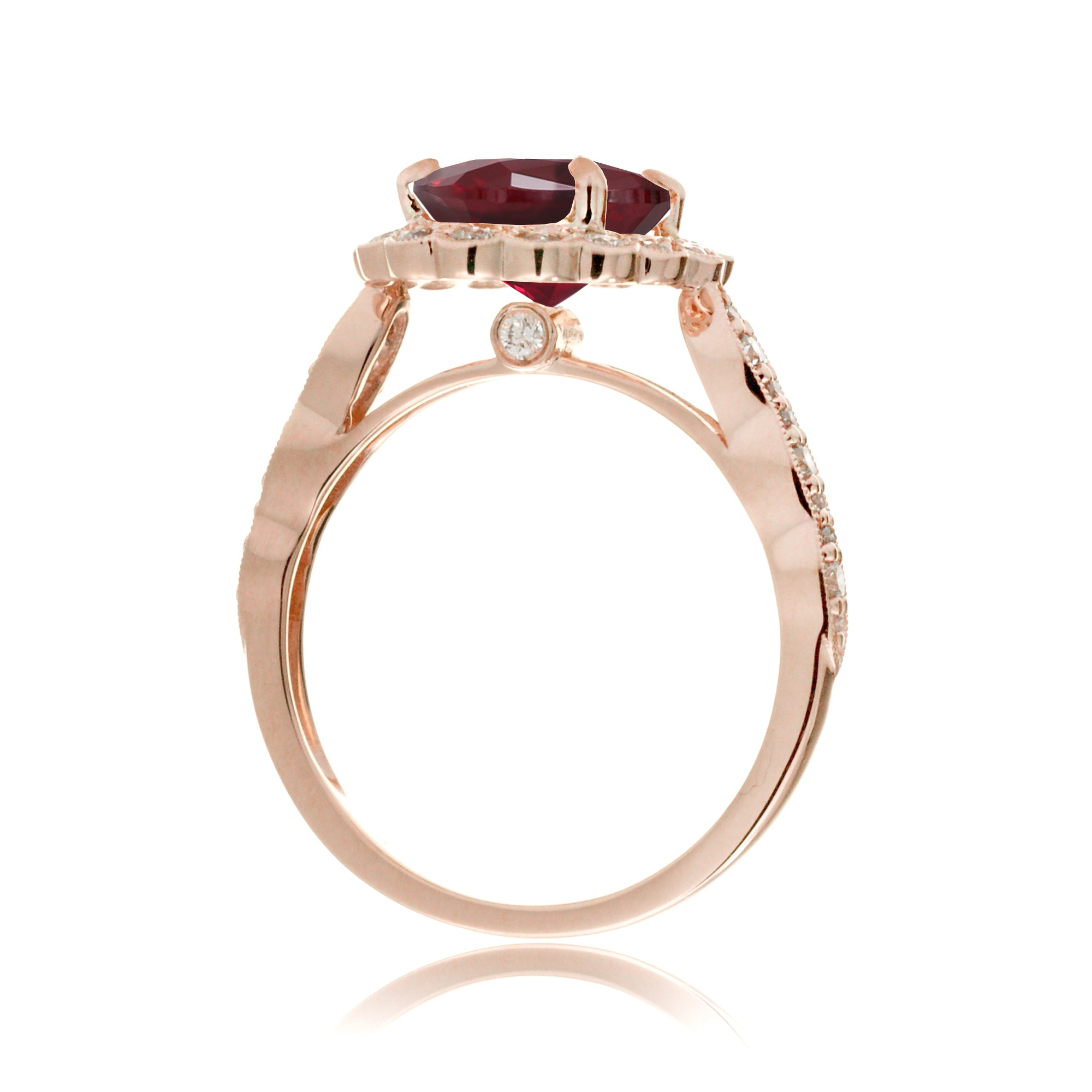 Oval cut ruby and diamond engagement ring with a vintage scallop band and halo rose gold