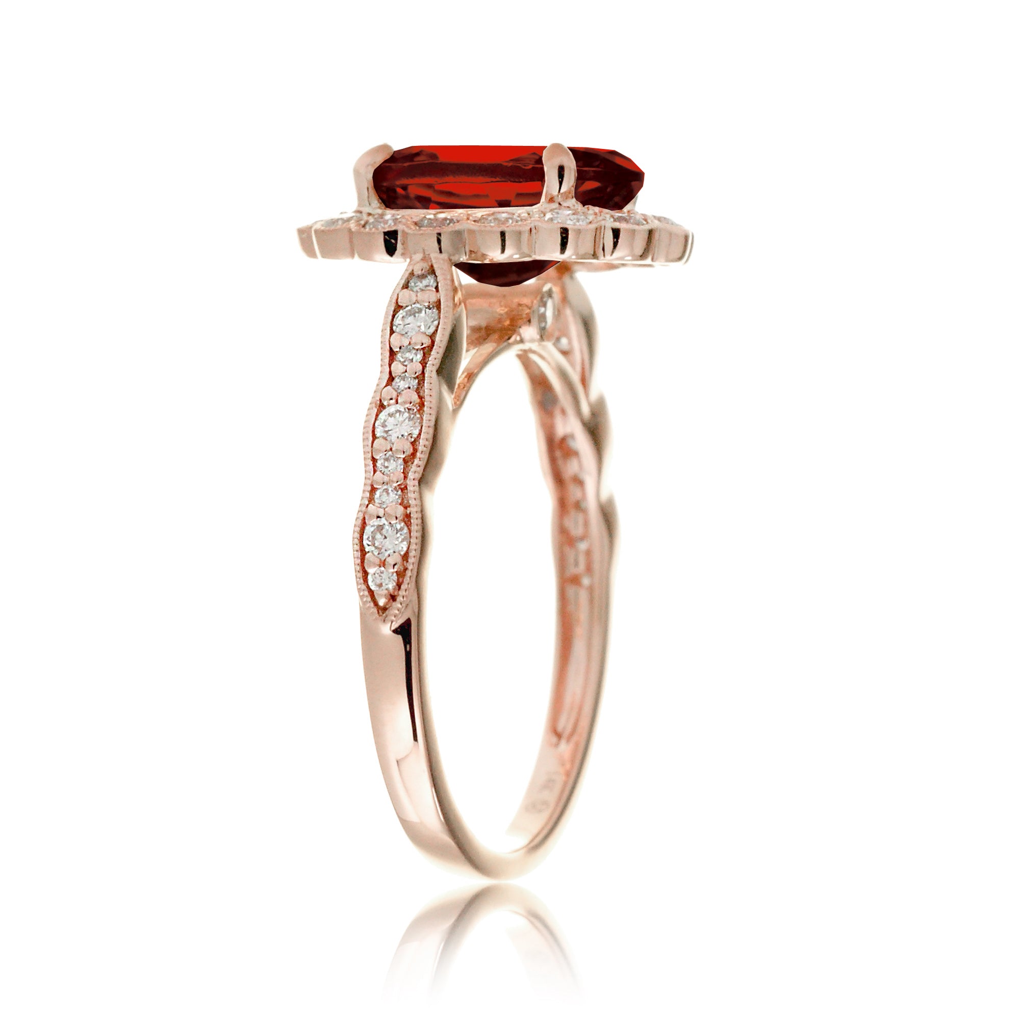 Oval cut ruby and diamond engagement ring with a vintage scallop band and halo rose gold