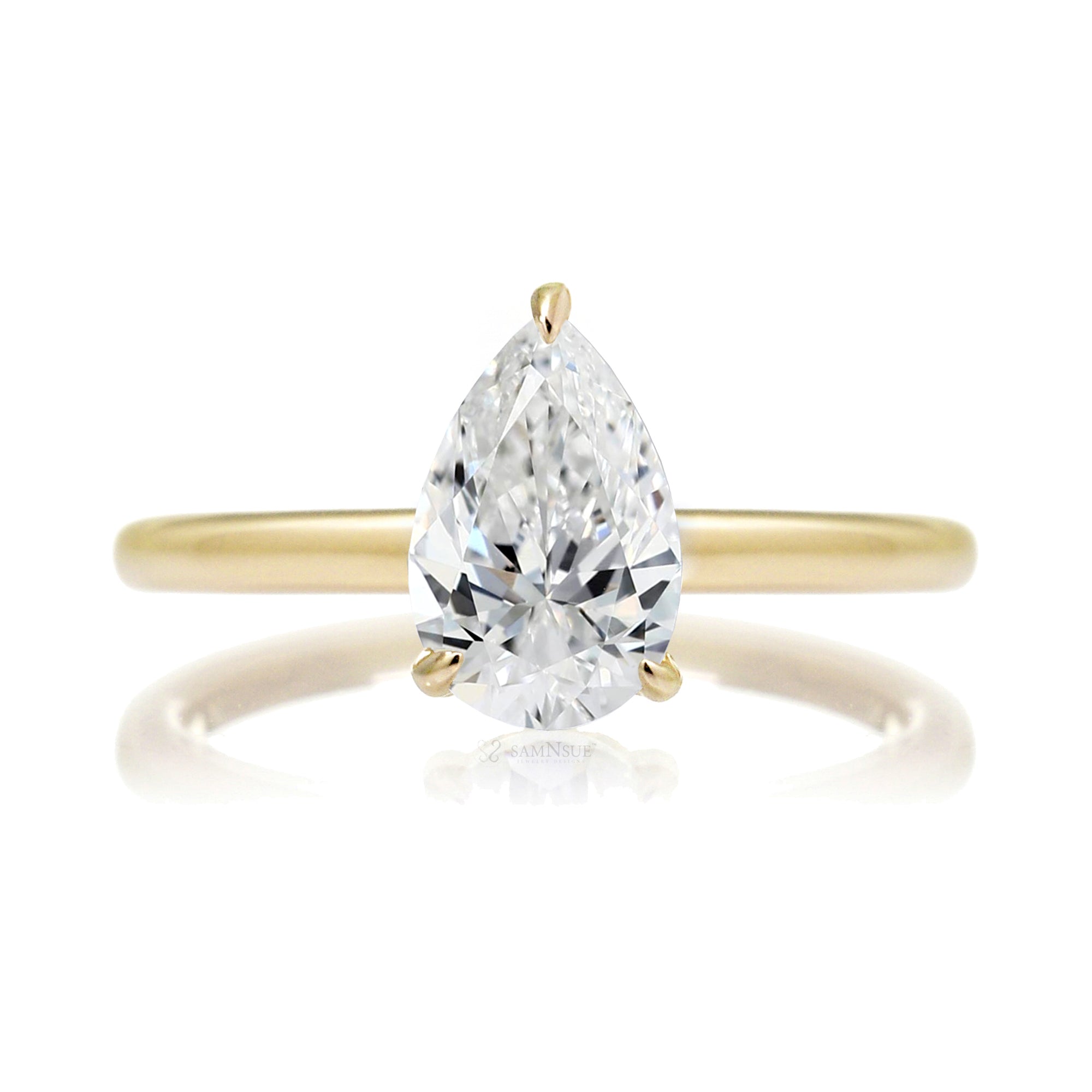 Pear cut solitaire diamond engagement ring with a hidden halo and solid polished band in yellow gold