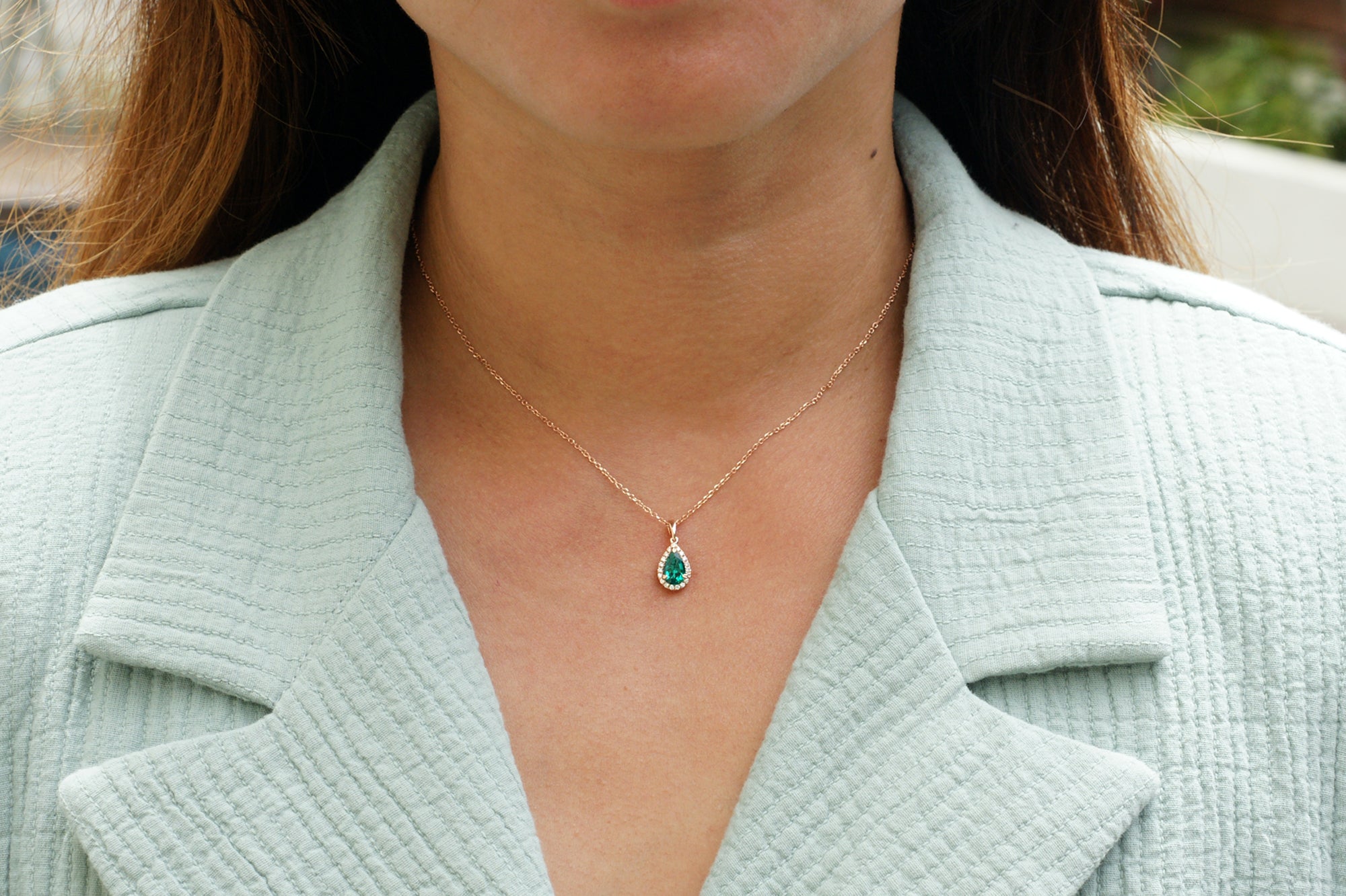 Pear green emerald pendant with diamond halo white gold
