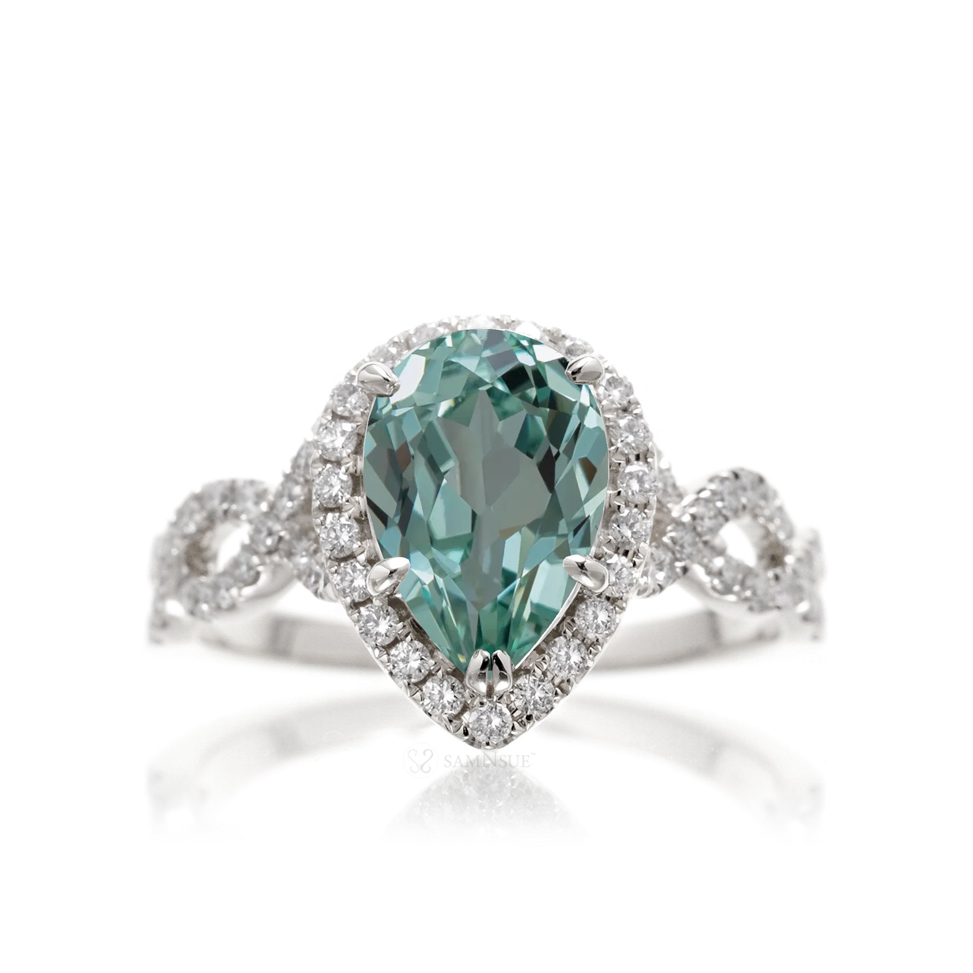 Twist band diamond halo ring with pear green sapphire white gold