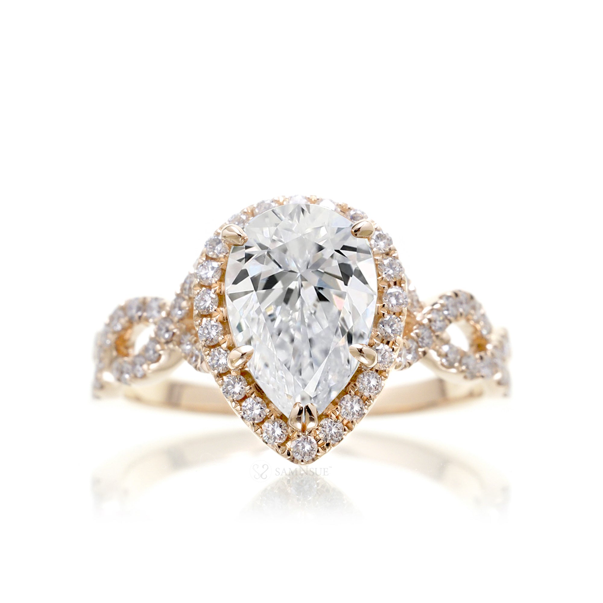 Pear diamond engagement ring halo and twist band yellow gold