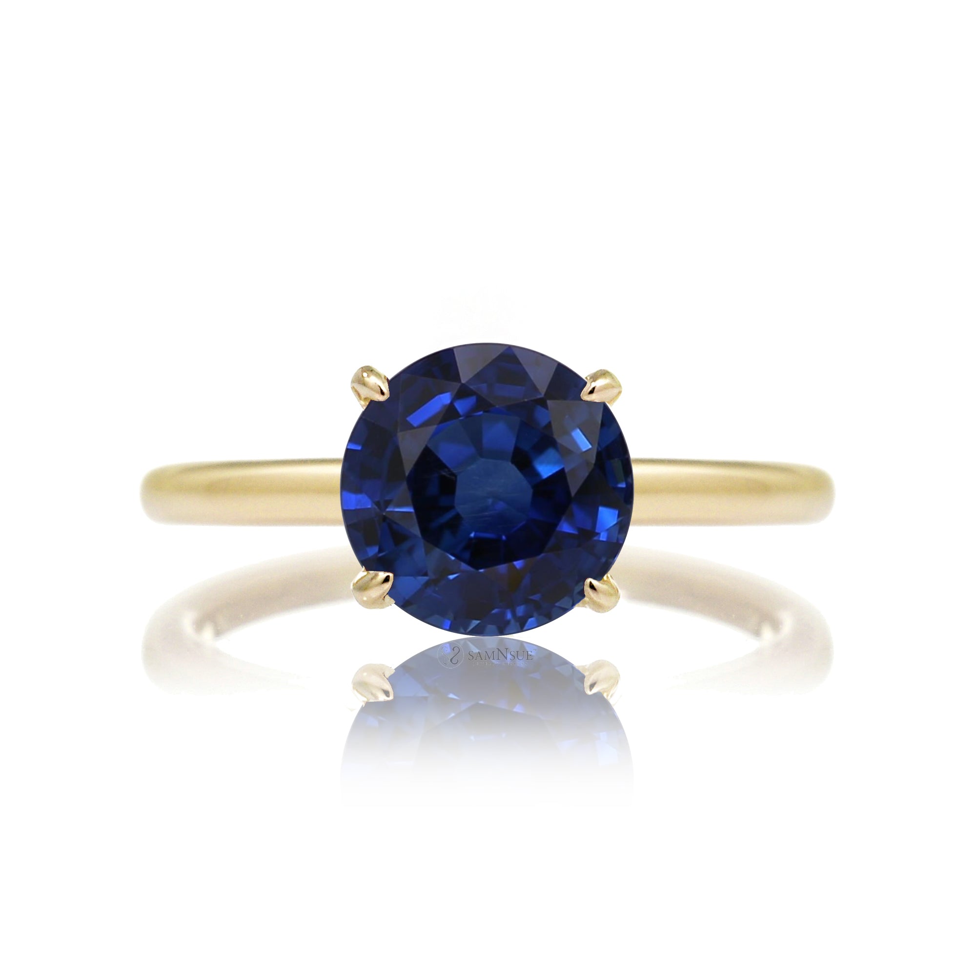Round cut blue lab-grown sapphire with diamond hidden halo on yellow gold