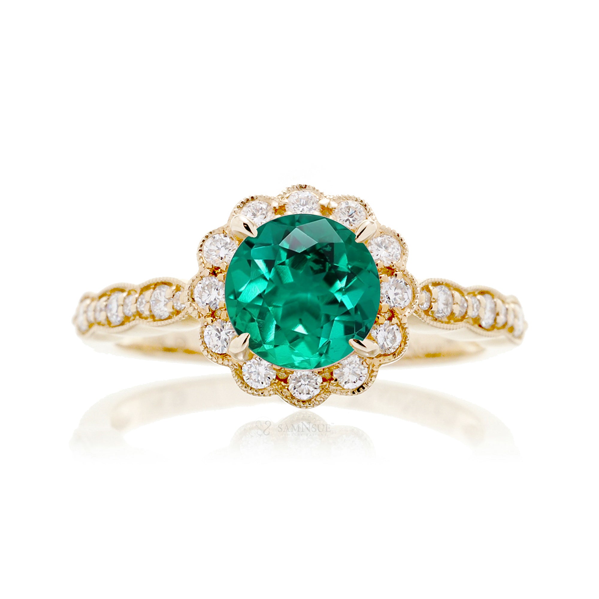 Round emerald engagement ring with scallop halo in yellow gold