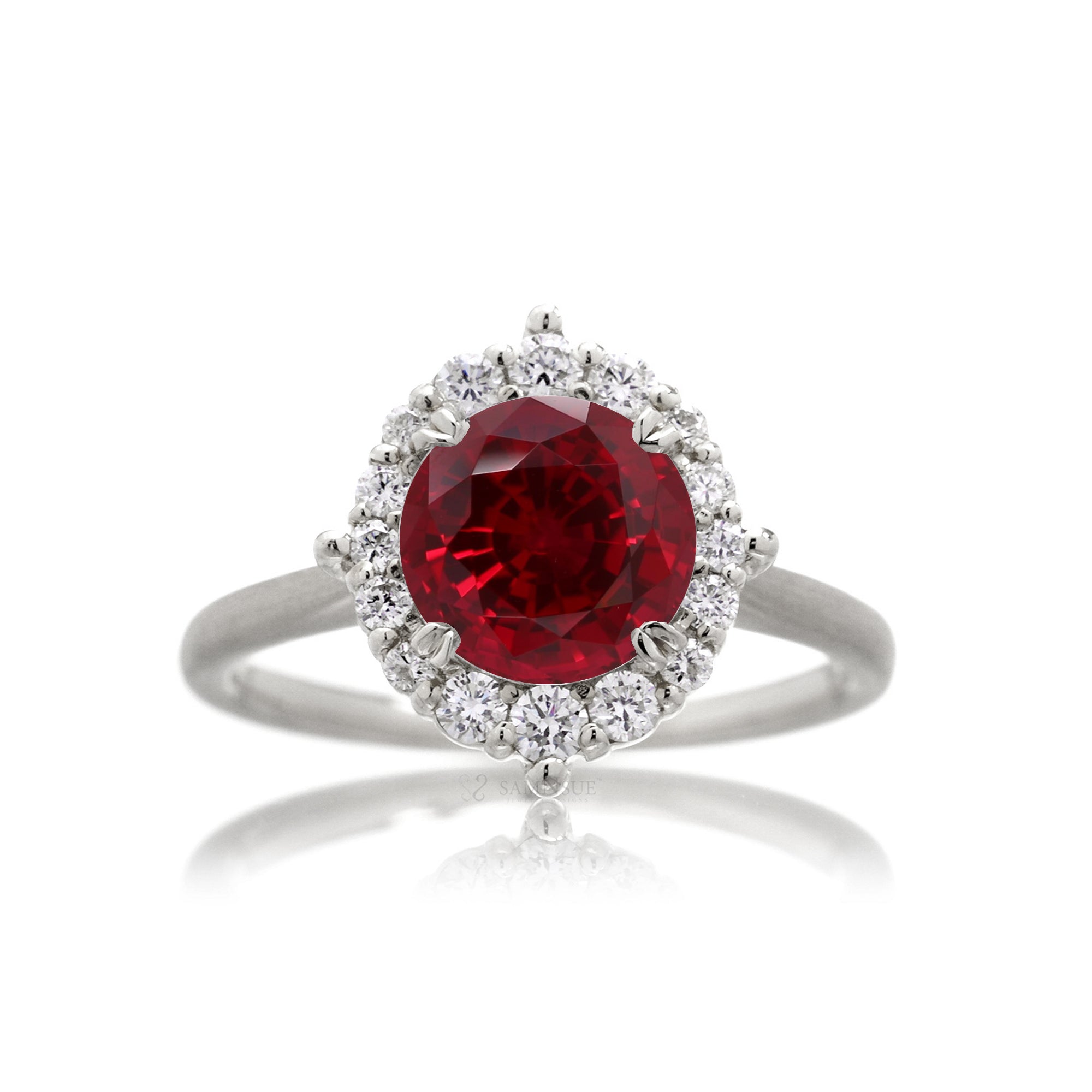 Round cut ruby diamond halo engagement ring with a solid white gold band