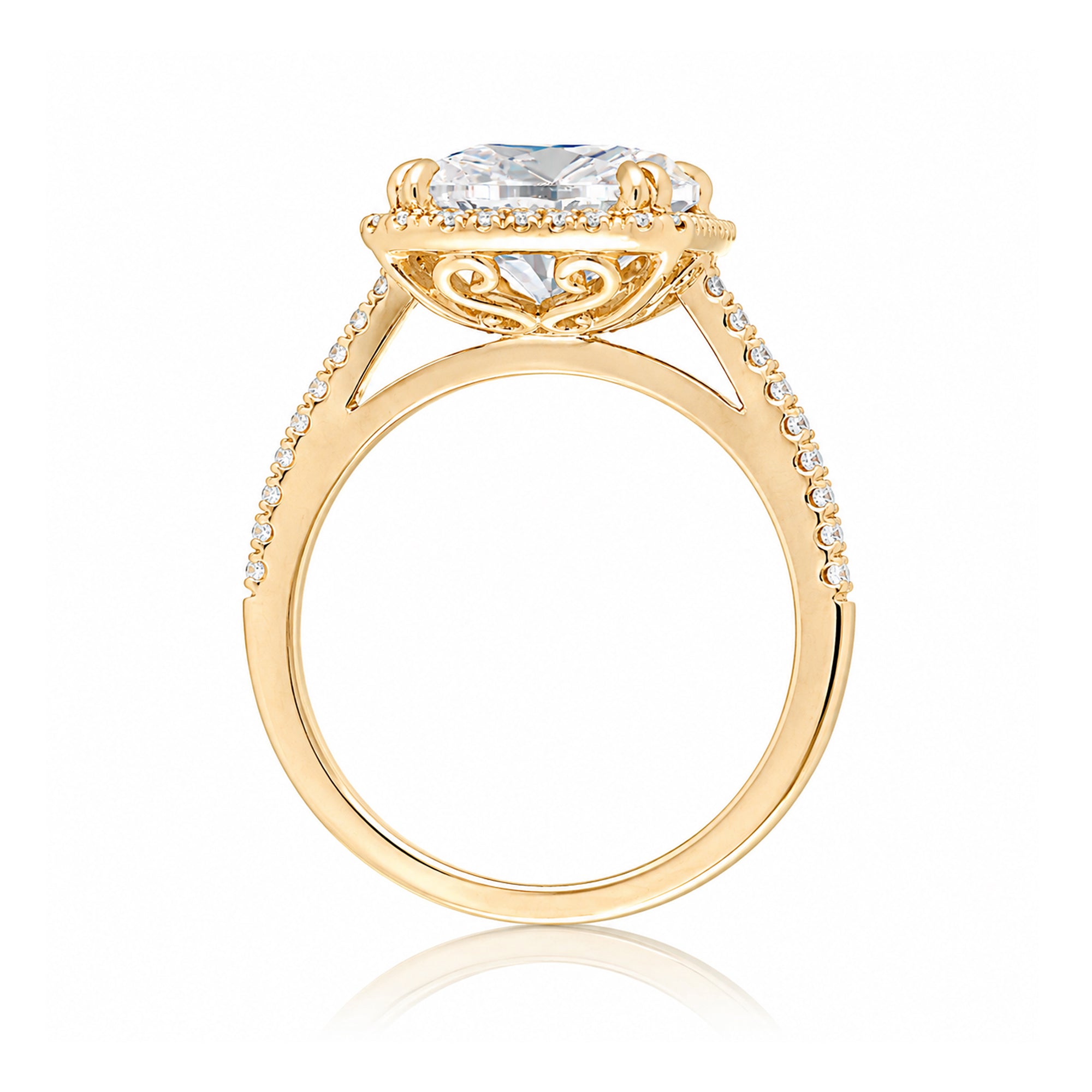 Emerald step cut diamond halo ring with a squarish band and cathedral setting yellow gold