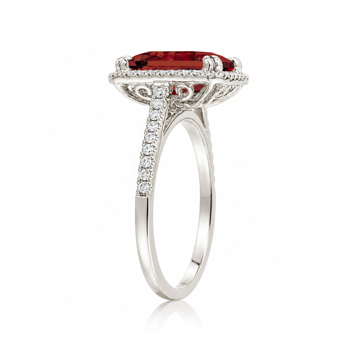 Emerald step cut ruby halo ring with a squarish band and cathedral setting white gold