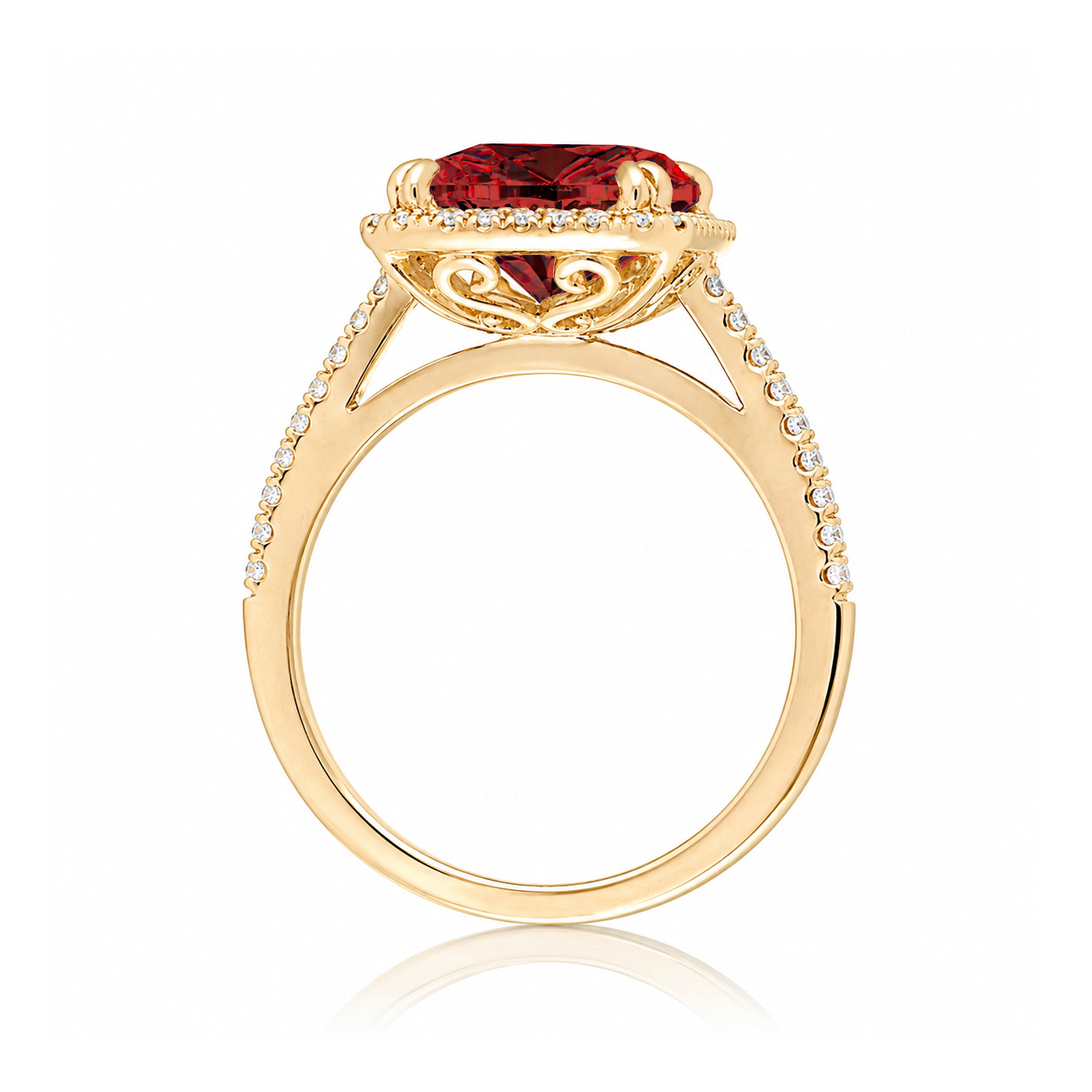 Emerald step cut ruby halo ring with a squarish band and cathedral setting yellow gold