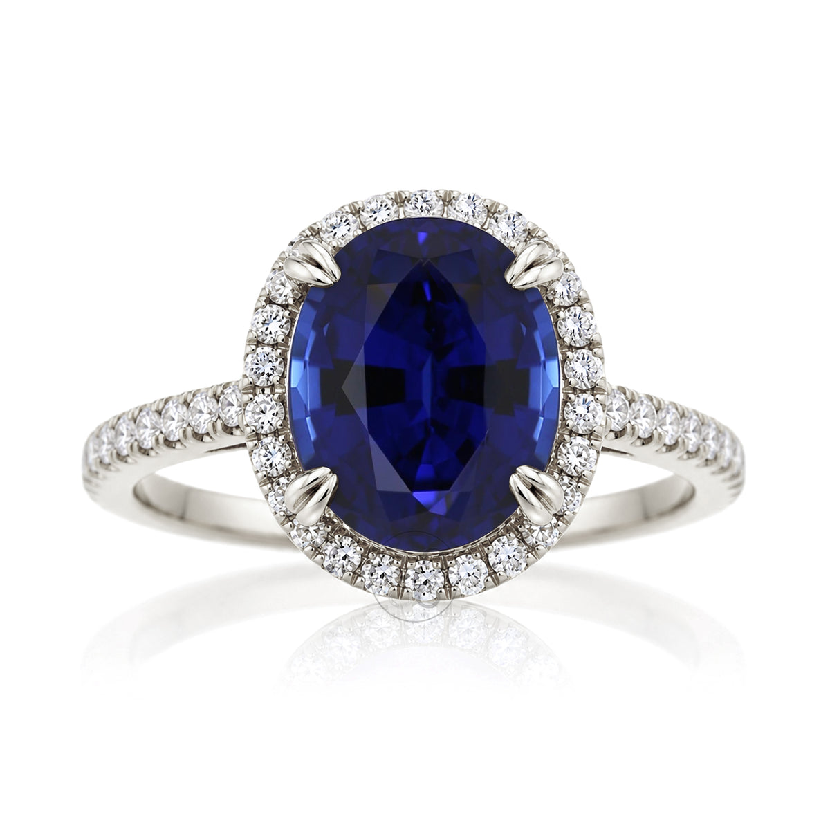 Oval blue sapphire engagement ring with diamond halo and square diamond band on a cathedral white gold setting