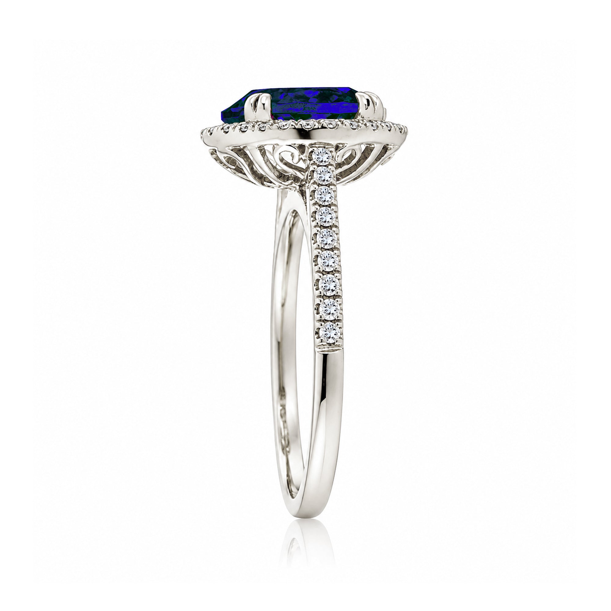 Oval blue sapphire engagement ring with diamond halo and square diamond band on a cathedral white gold setting