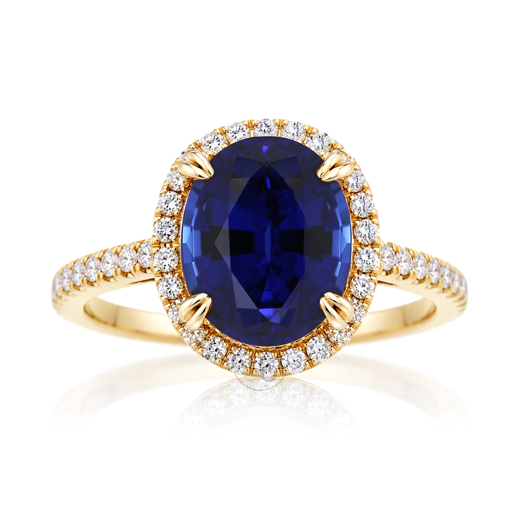 Oval blue sapphire engagement ring with diamond halo and square diamond band on a cathedral yellow gold setting