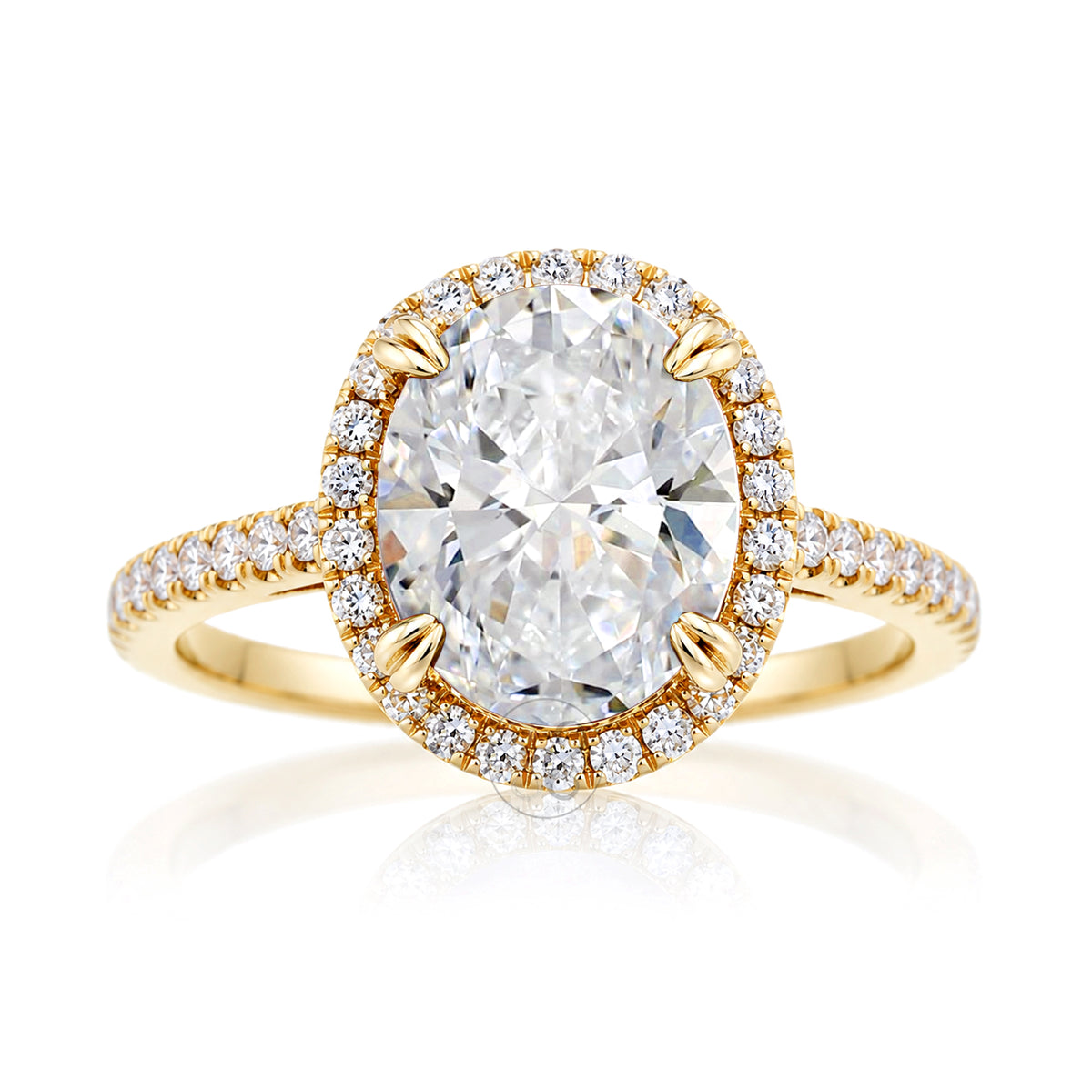 Oval diamond engagement ring with halo and cathedral setting in yellow gold