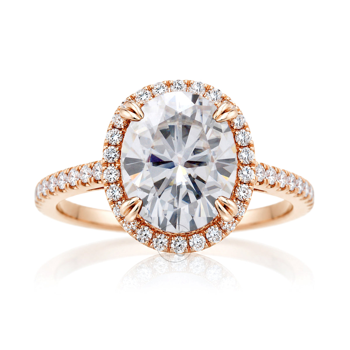 Oval moissanite engagement ring with a diamond halo and squarish diamond band on a cathedral rose gold setting