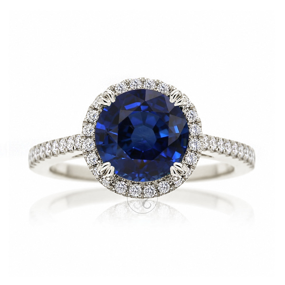 Round blue sapphire diamond halo ring with squarish diamond band white gold