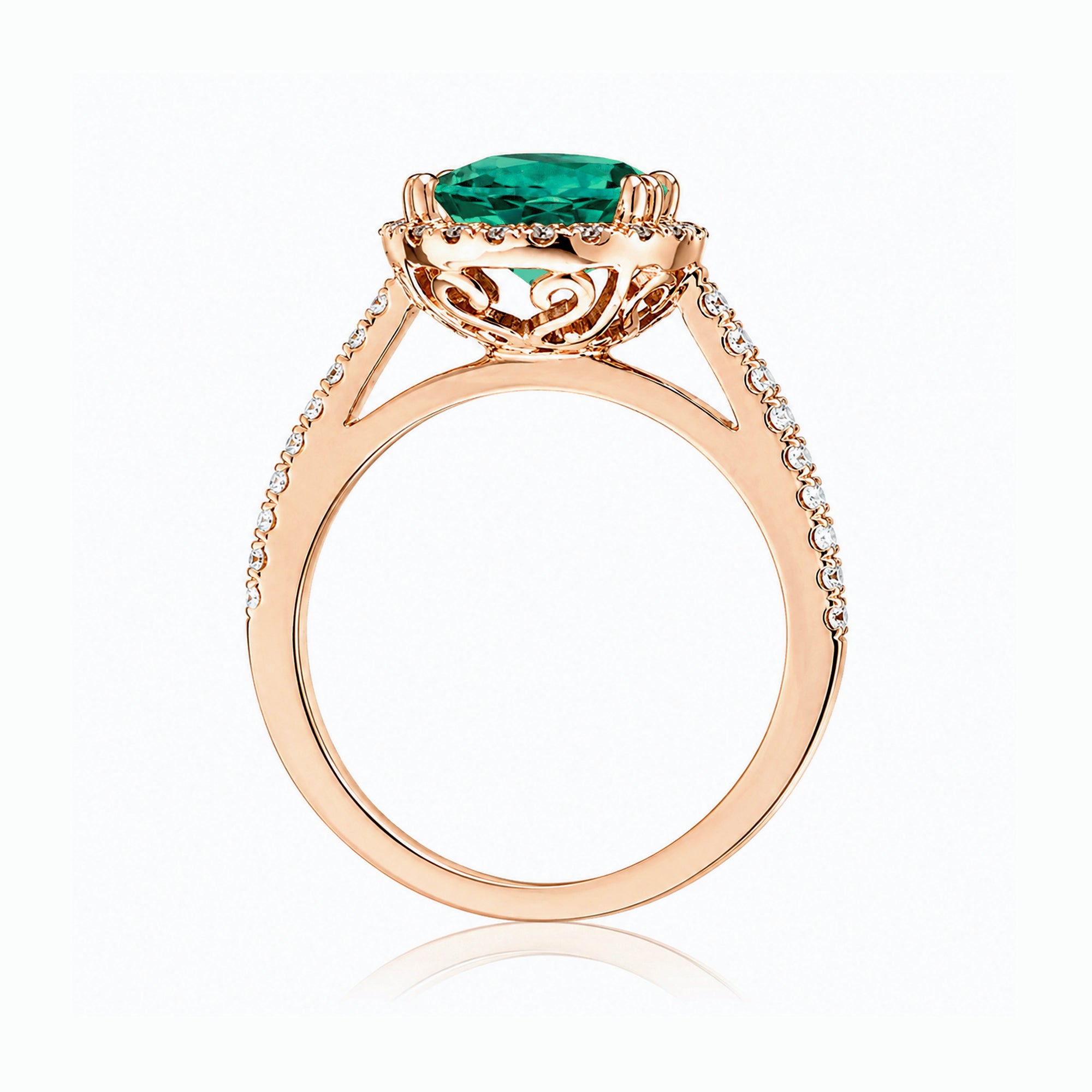 Round emerald diamond halo ring with squarish diamond band rose gold