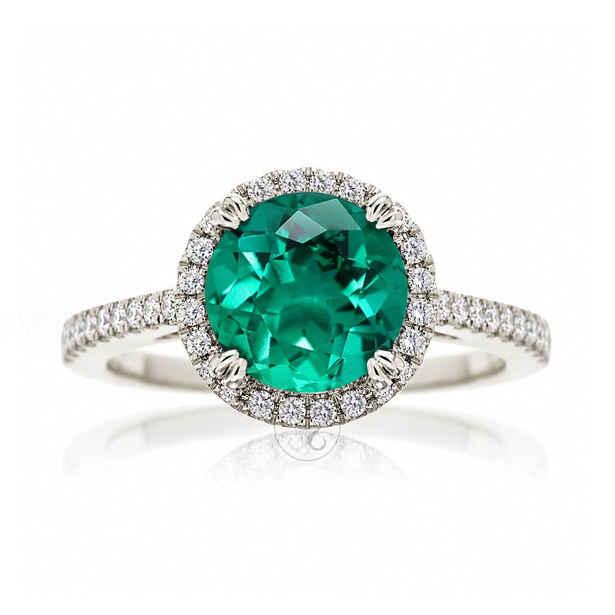 Round emerald diamond halo ring with squarish diamond band white gold