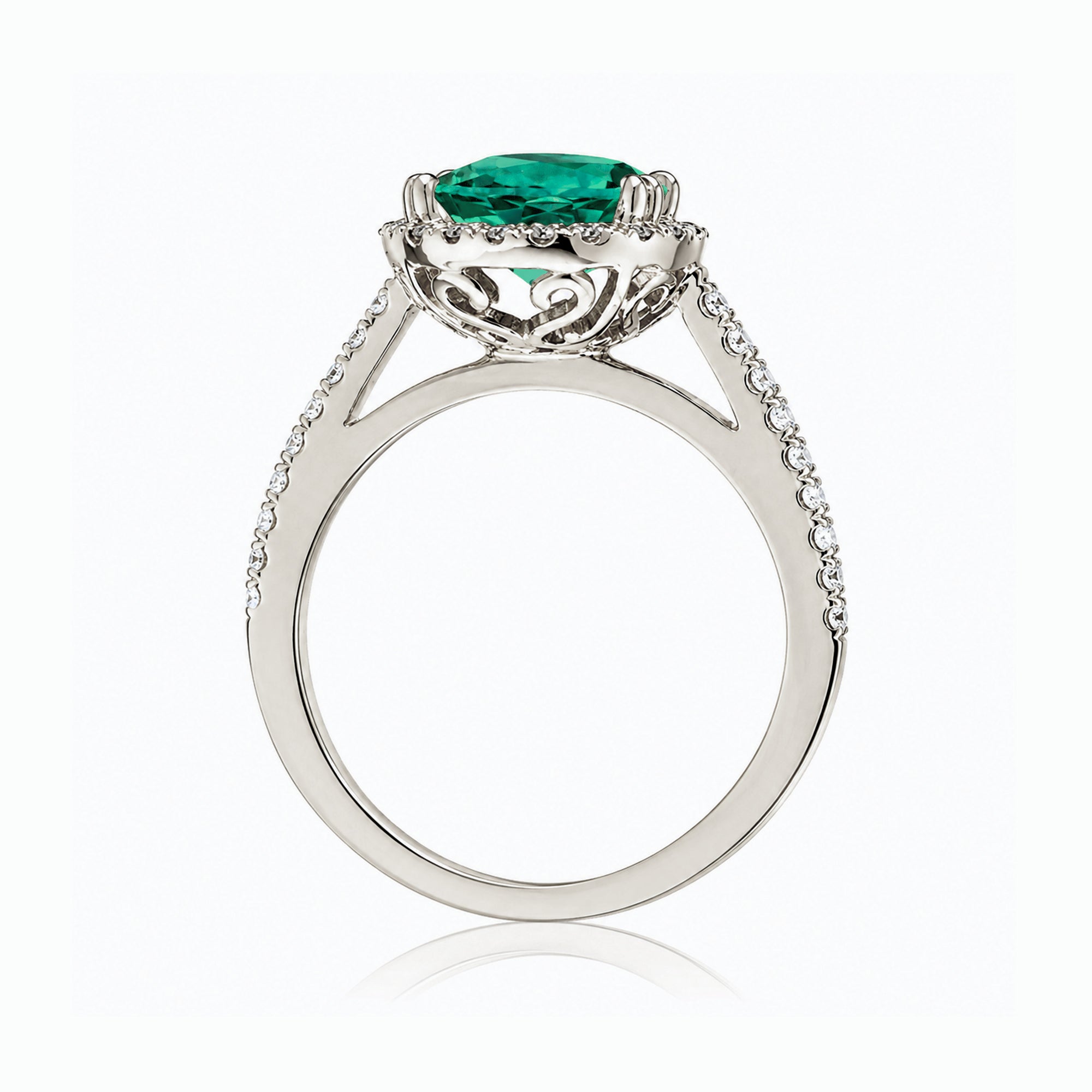 Round emerald diamond halo ring with squarish diamond band white gold