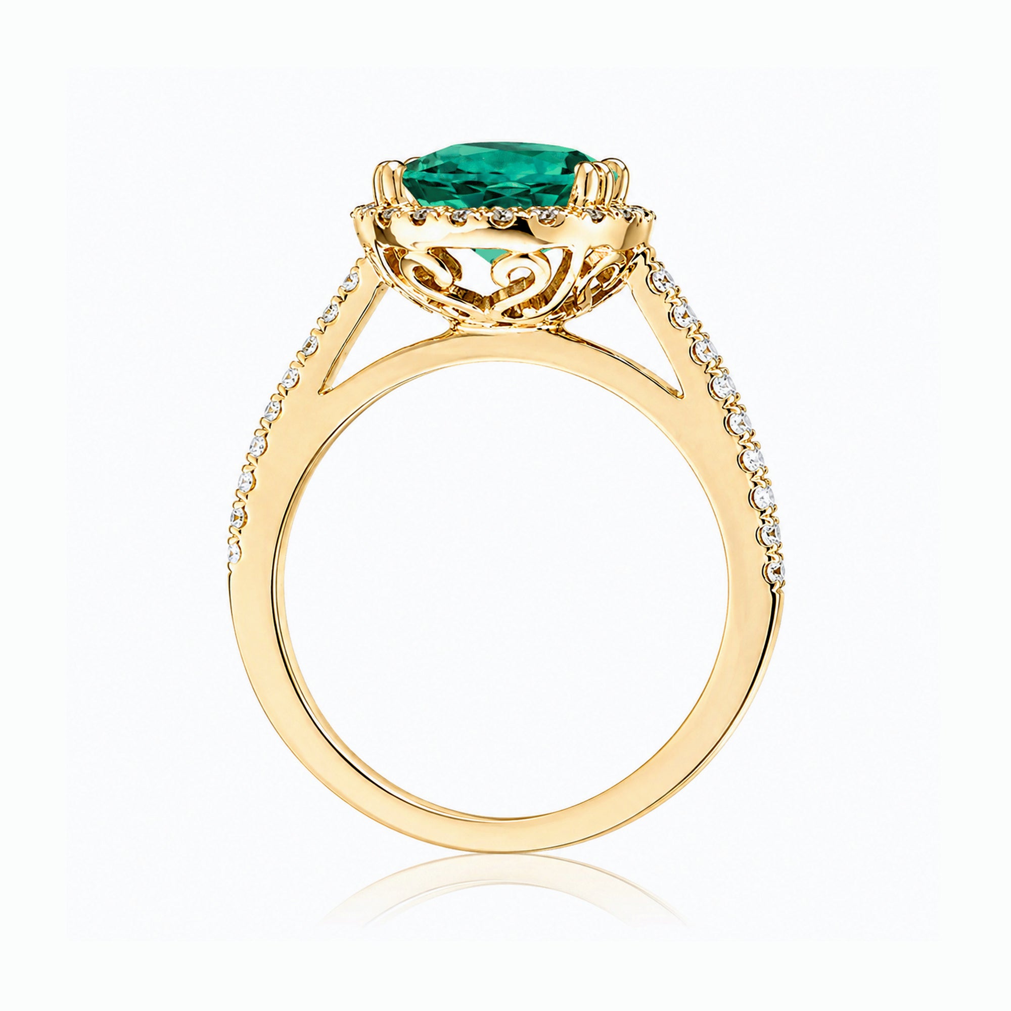 Round emerald diamond halo ring with squarish diamond band yellow gold