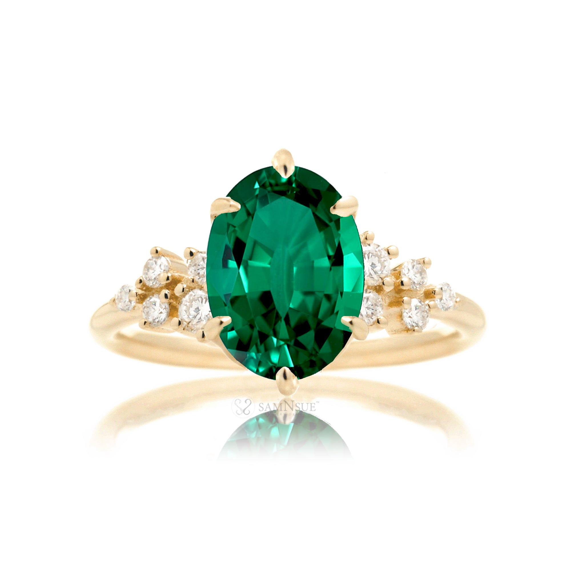 Oval emerald ring with diamond accent on yellow gold