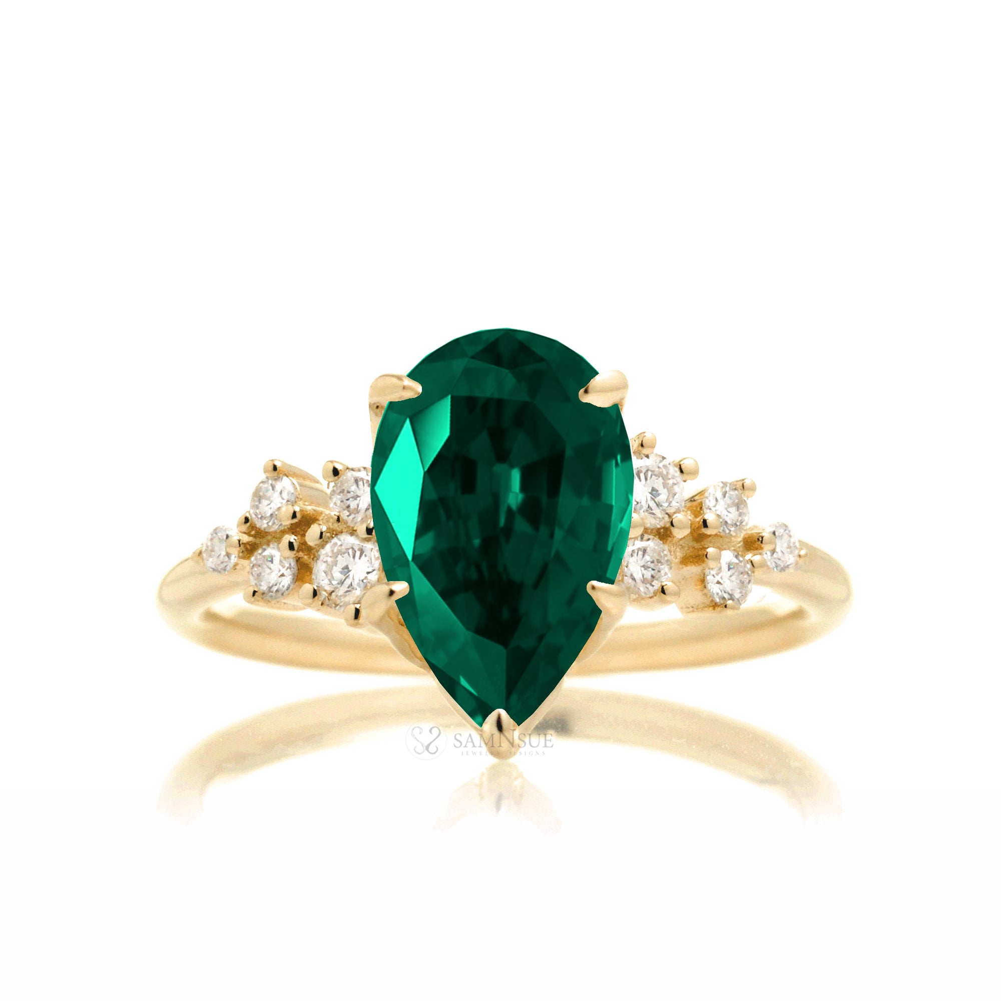 Pear green emerald and diamond three stone ring yellow gold