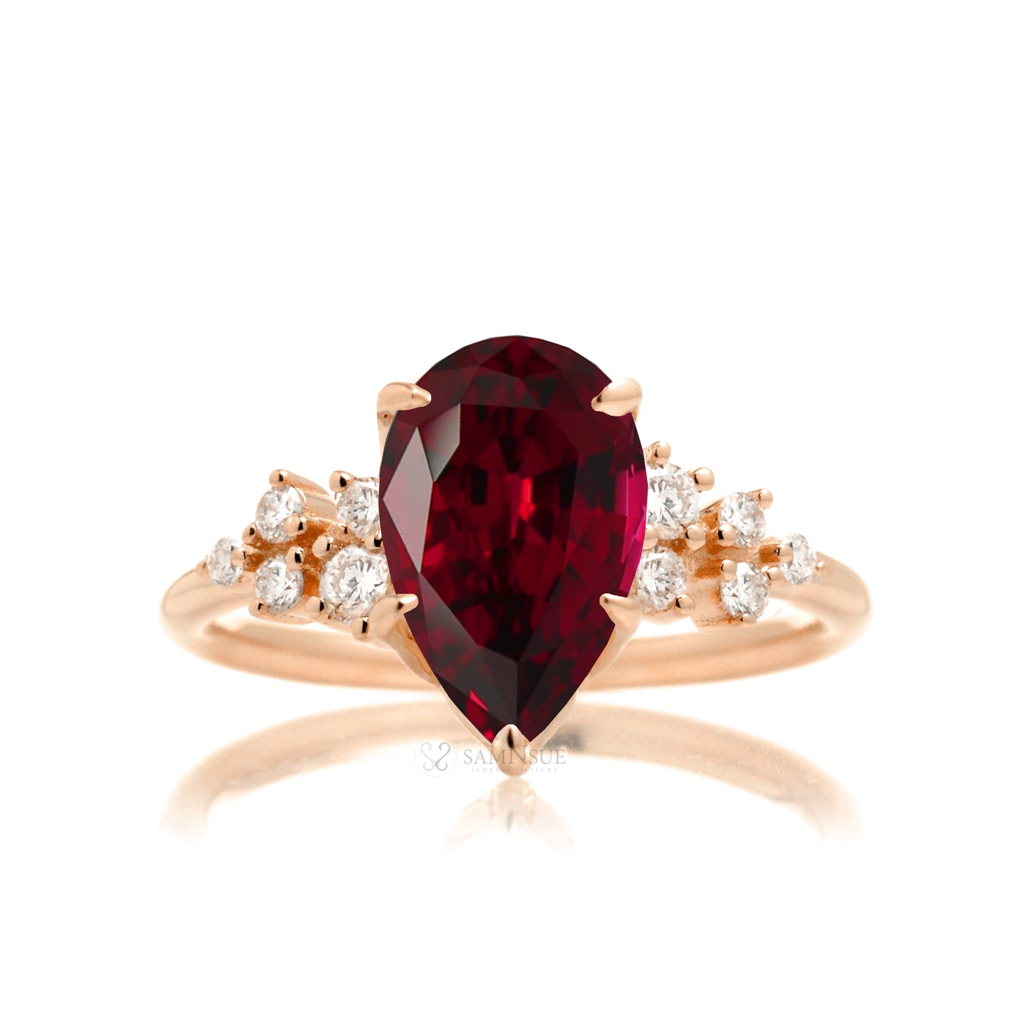 Pear ruby and diamond three stone ring rose gold