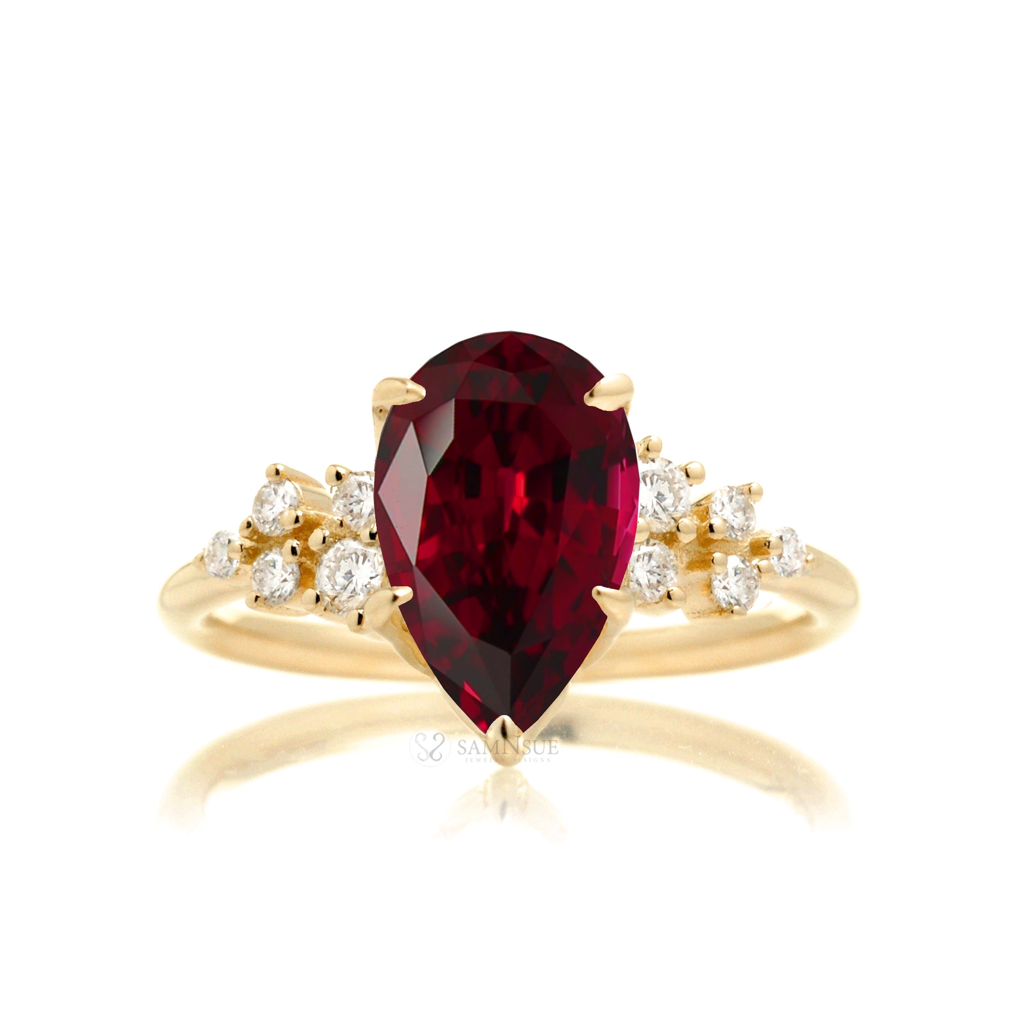Pear ruby and diamond three stone ring yellow gold