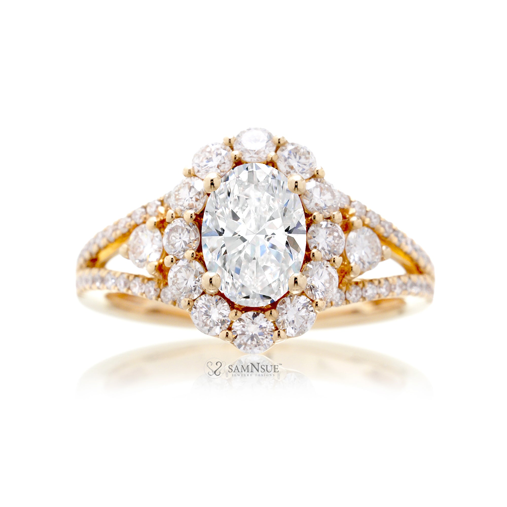 Oval diamond ring with halo split band and three stone design in yellow gold