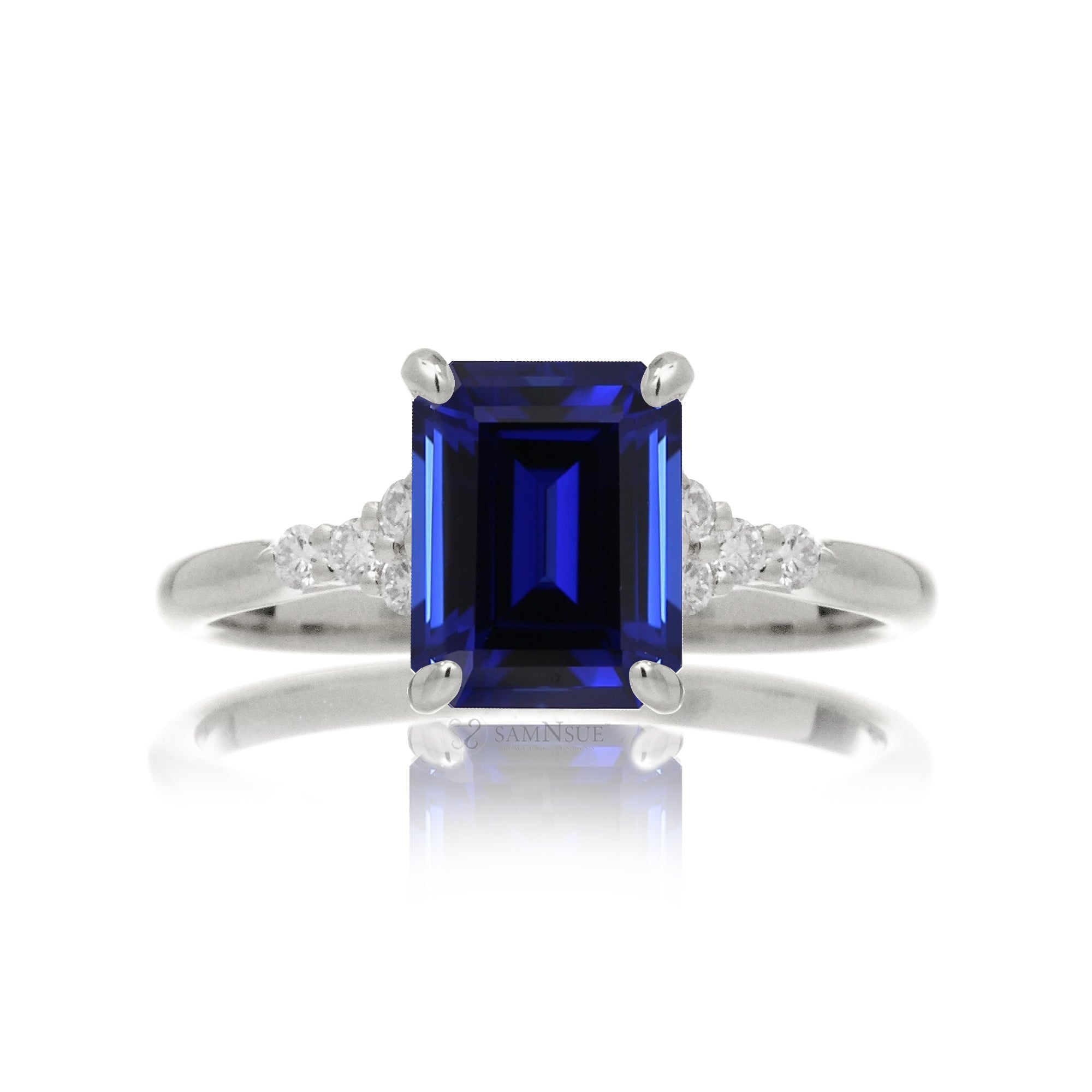Sapphire engagement ring with a blue step emerald cut lab-grown sapphire and diamond accent in white gold