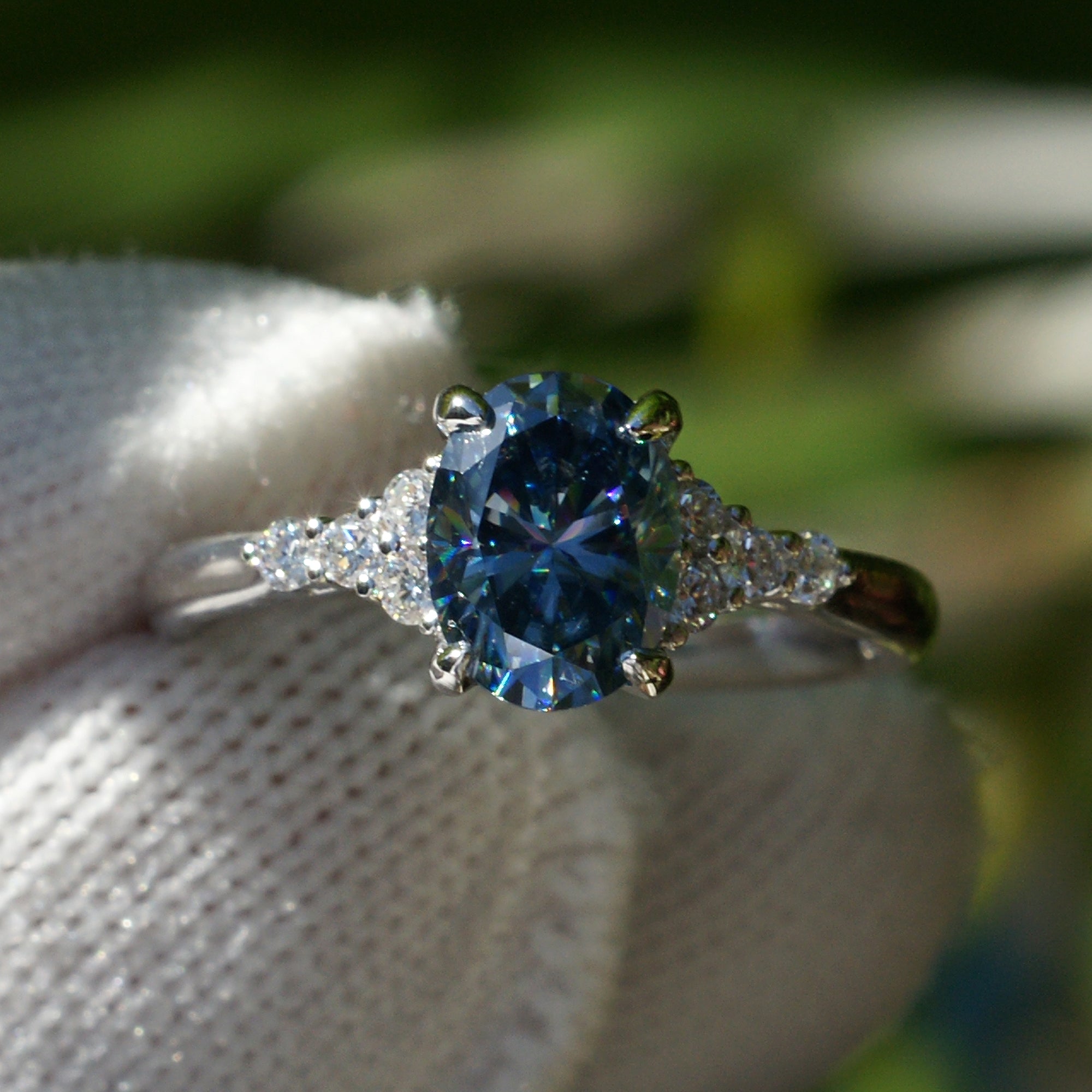 Oval grey blue moissanite and diamond three stone engagement ring in white gold