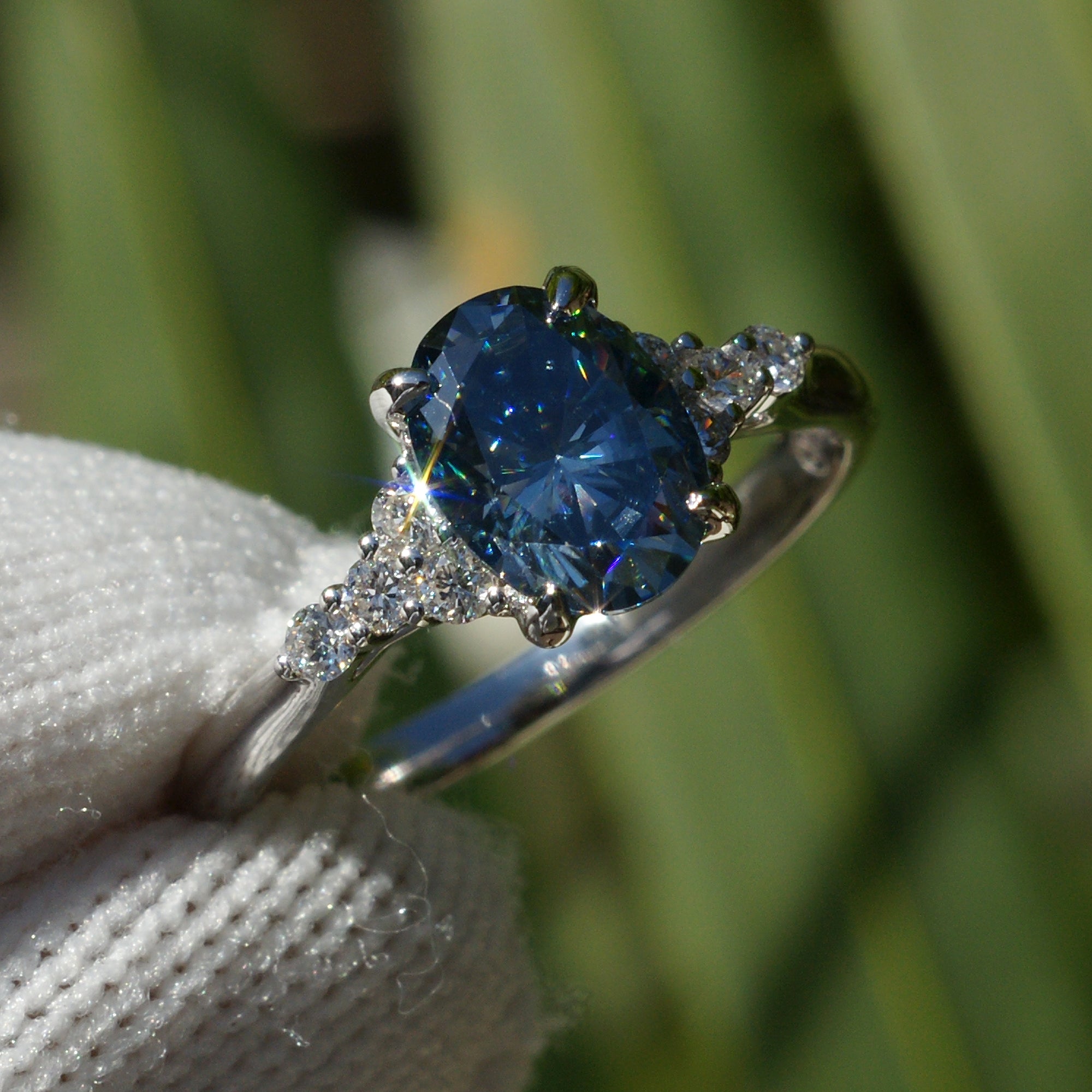 Oval grey blue moissanite and diamond three stone engagement ring in white gold