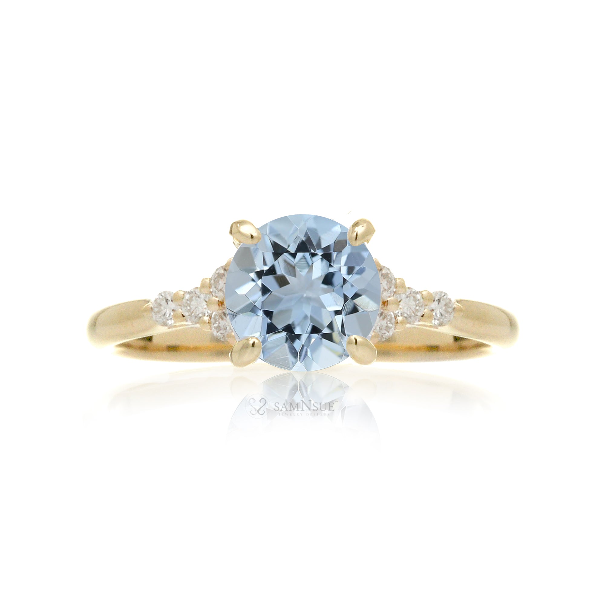 Round aquamarine three stone ring in yellow gold