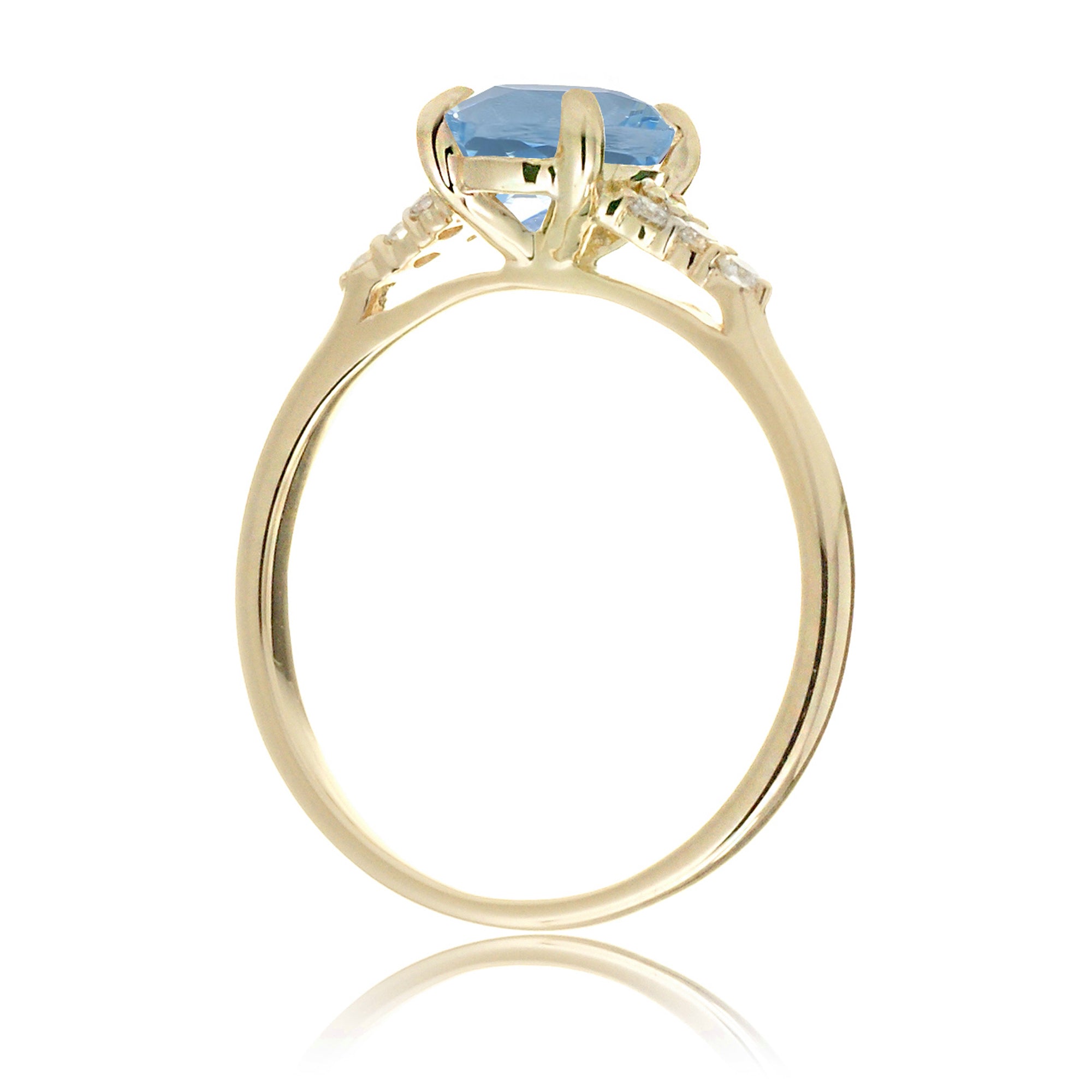 Round aquamarine three stone ring in yellow gold