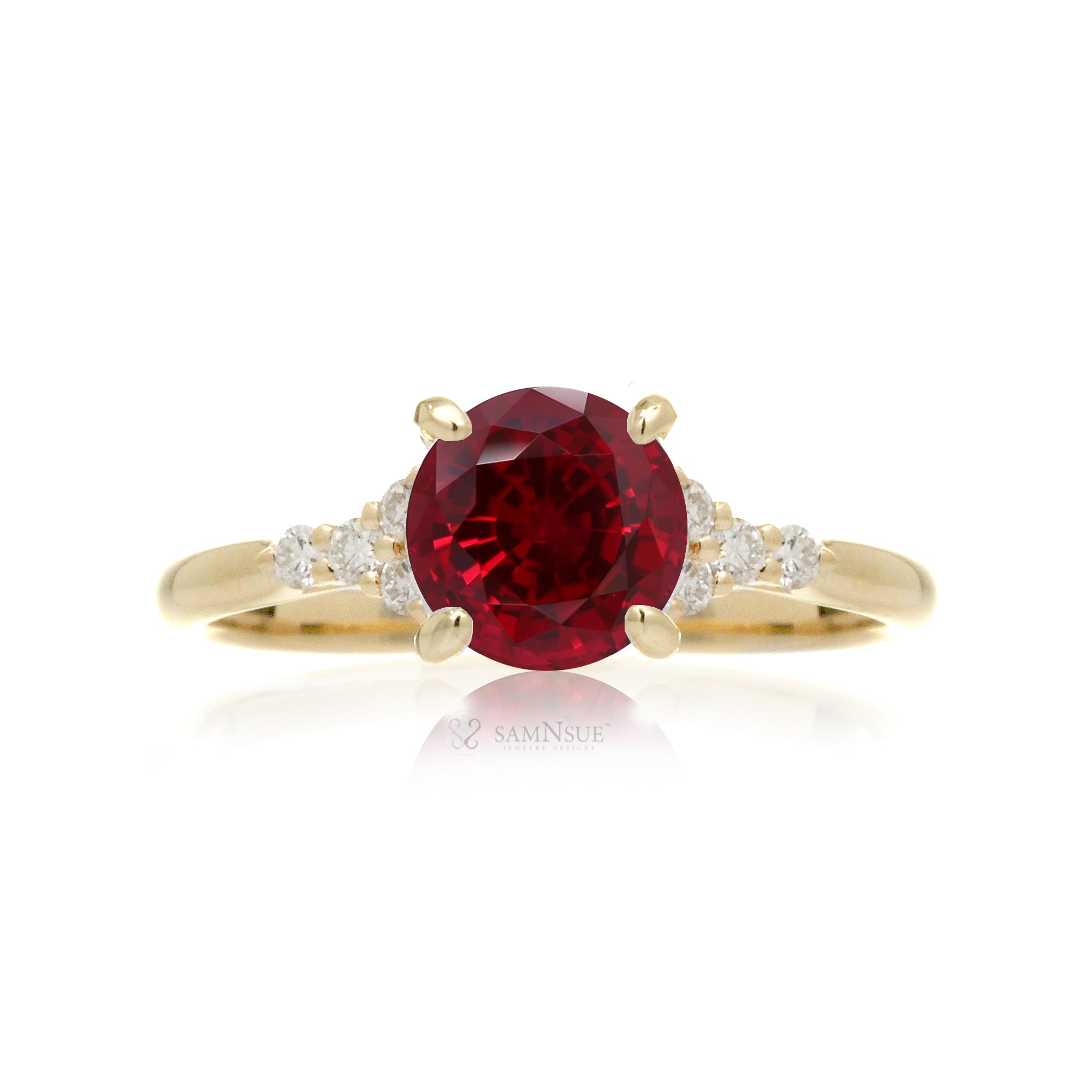 Round cut ruby three stone diamond ring in yellow gold