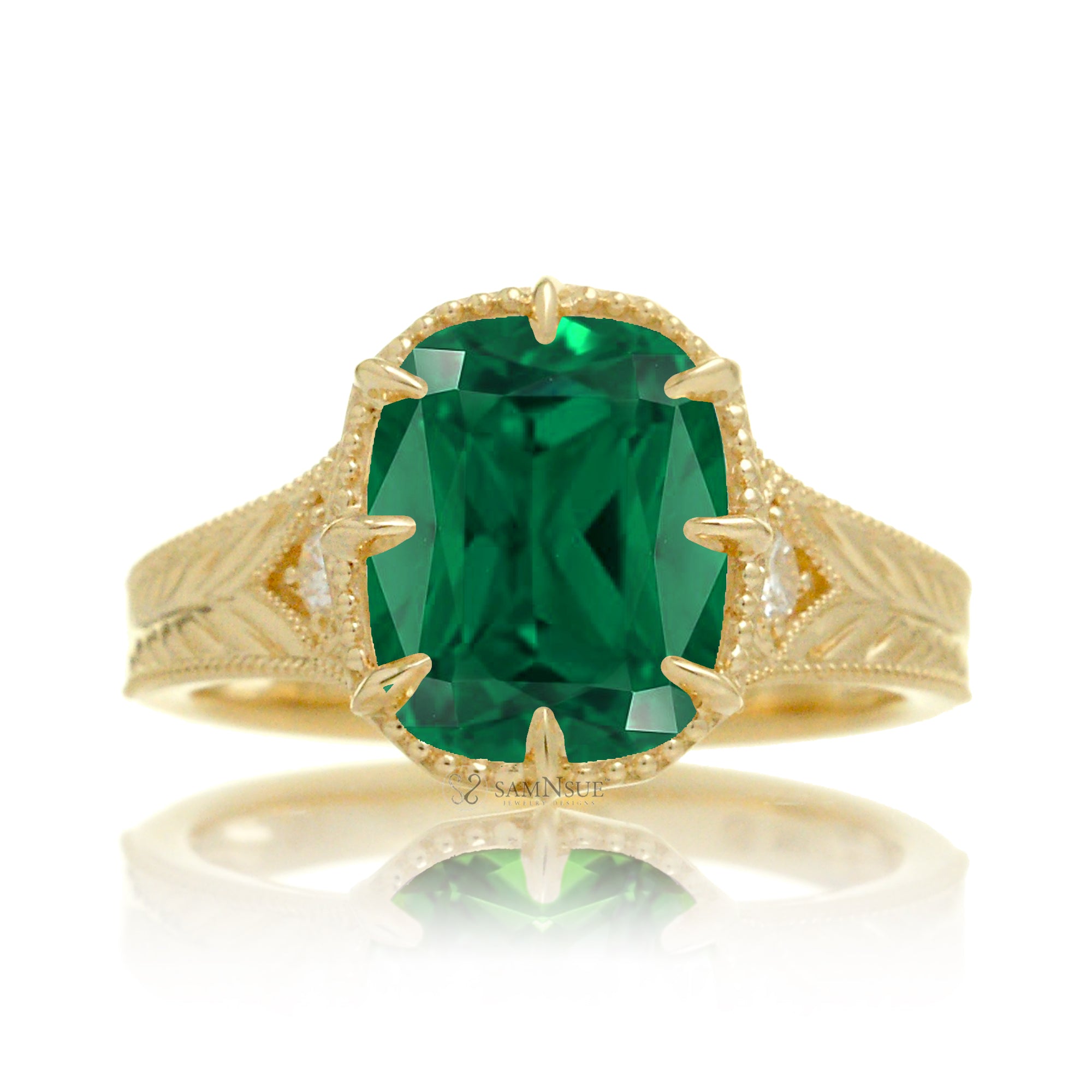 This heirloom-style ring showcases a cushion-shaped emerald. The warm yellow gold setting, paired with intricate engraving, creates a romantic design reminiscent of old-world glamour.