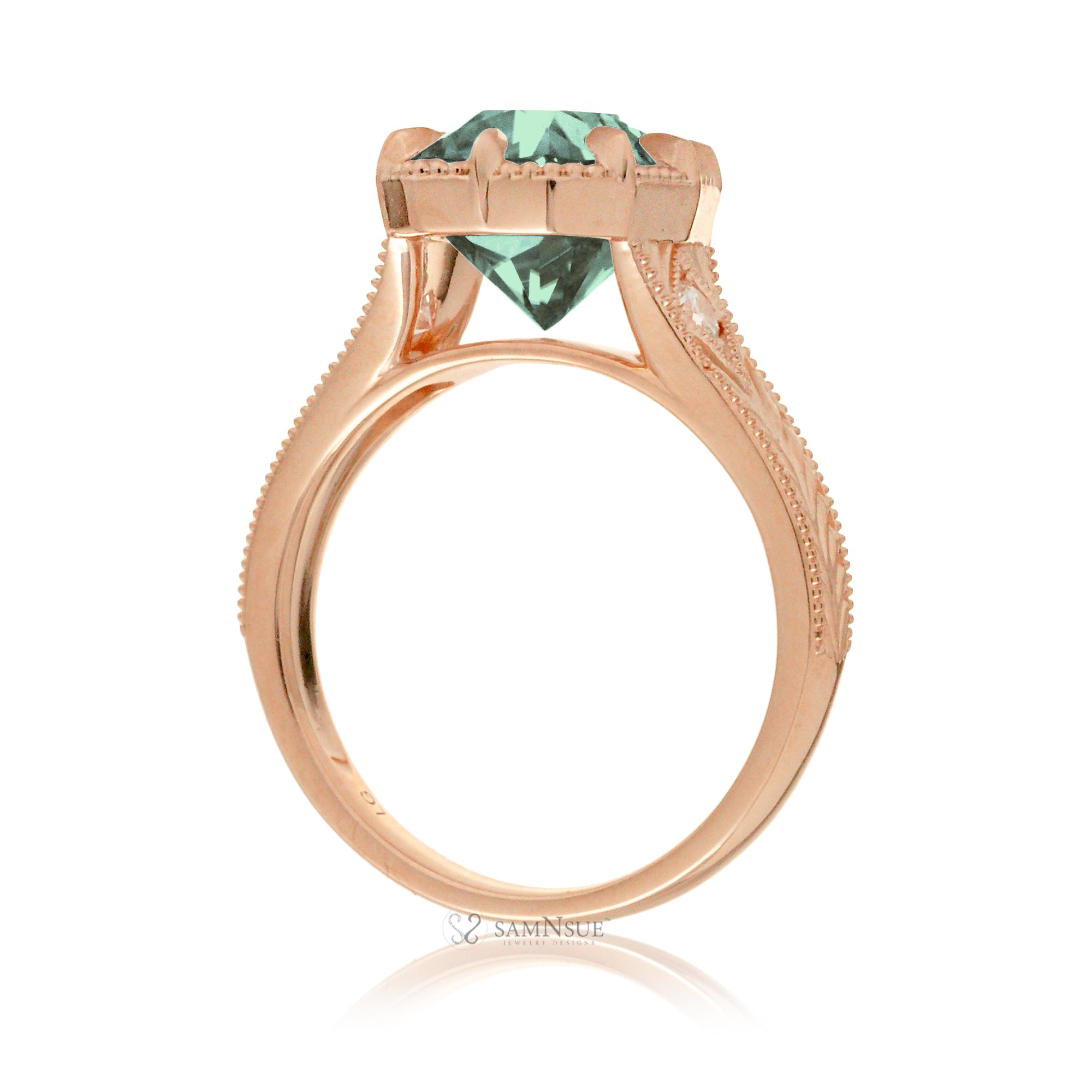 The Kelcey is a vintage-inspired green sapphire ring showcasing a cushion cut green sapphire, admired for its rich, vibrant green brilliance.