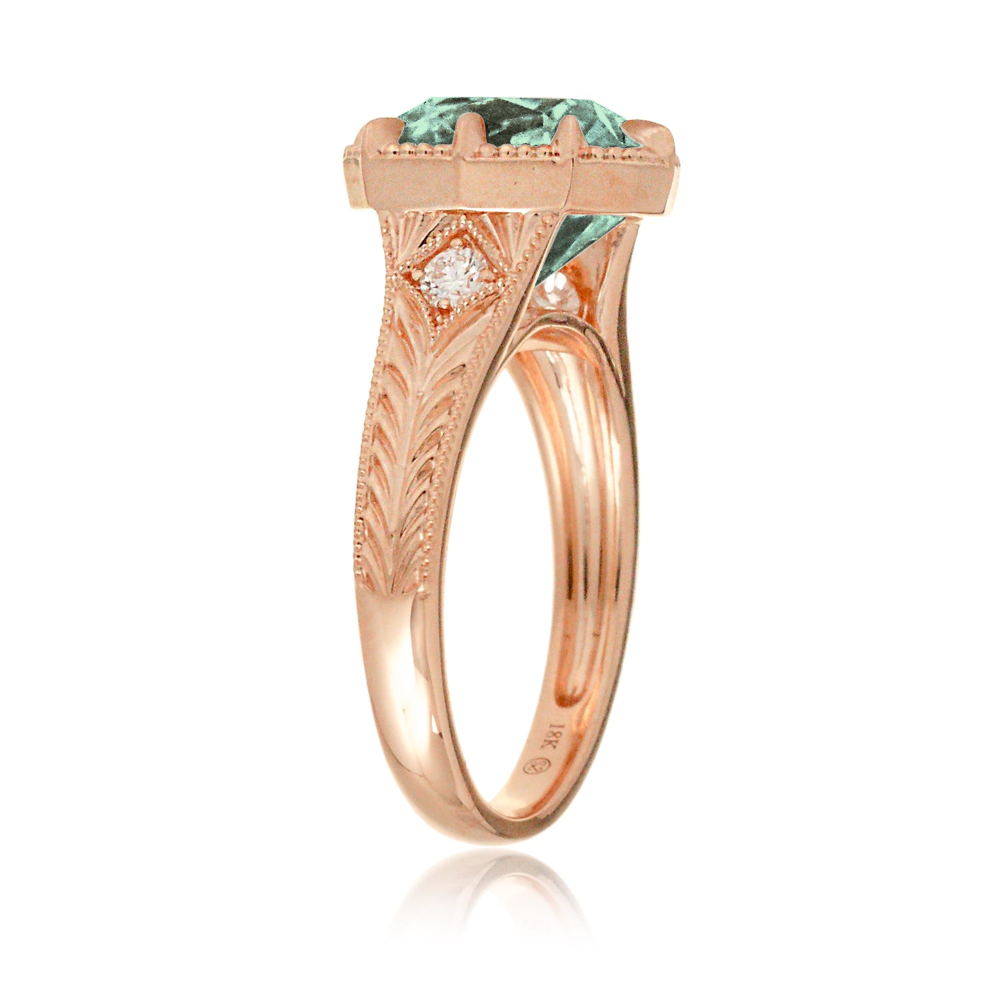 The Kelcey is a vintage-inspired green sapphire ring showcasing a cushion cut green sapphire, admired for its rich, vibrant green brilliance.