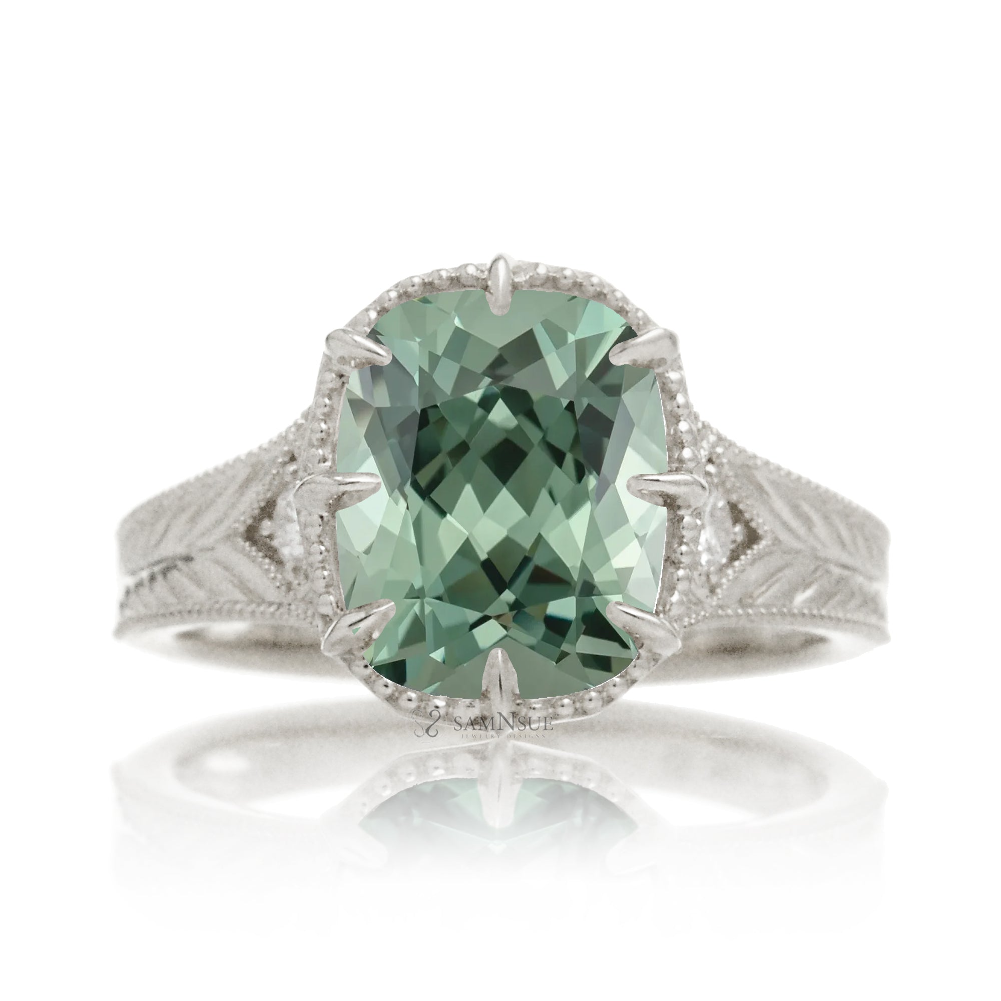 The Kelcey is a vintage-inspired green sapphire ring showcasing a cushion cut green sapphire, admired for its rich, vibrant green brilliance.