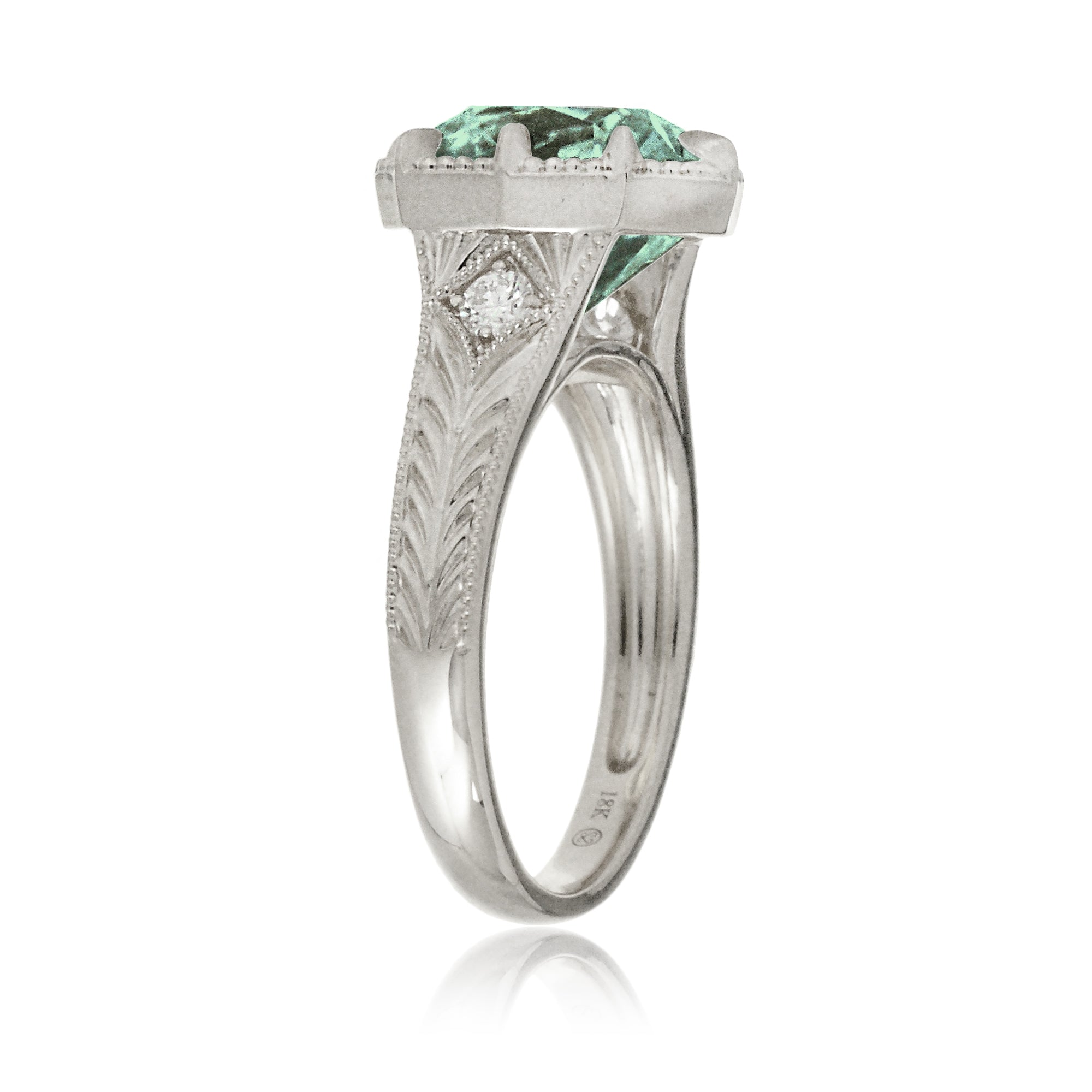 The Kelcey is a vintage-inspired green sapphire ring showcasing a cushion cut green sapphire, admired for its rich, vibrant green brilliance.