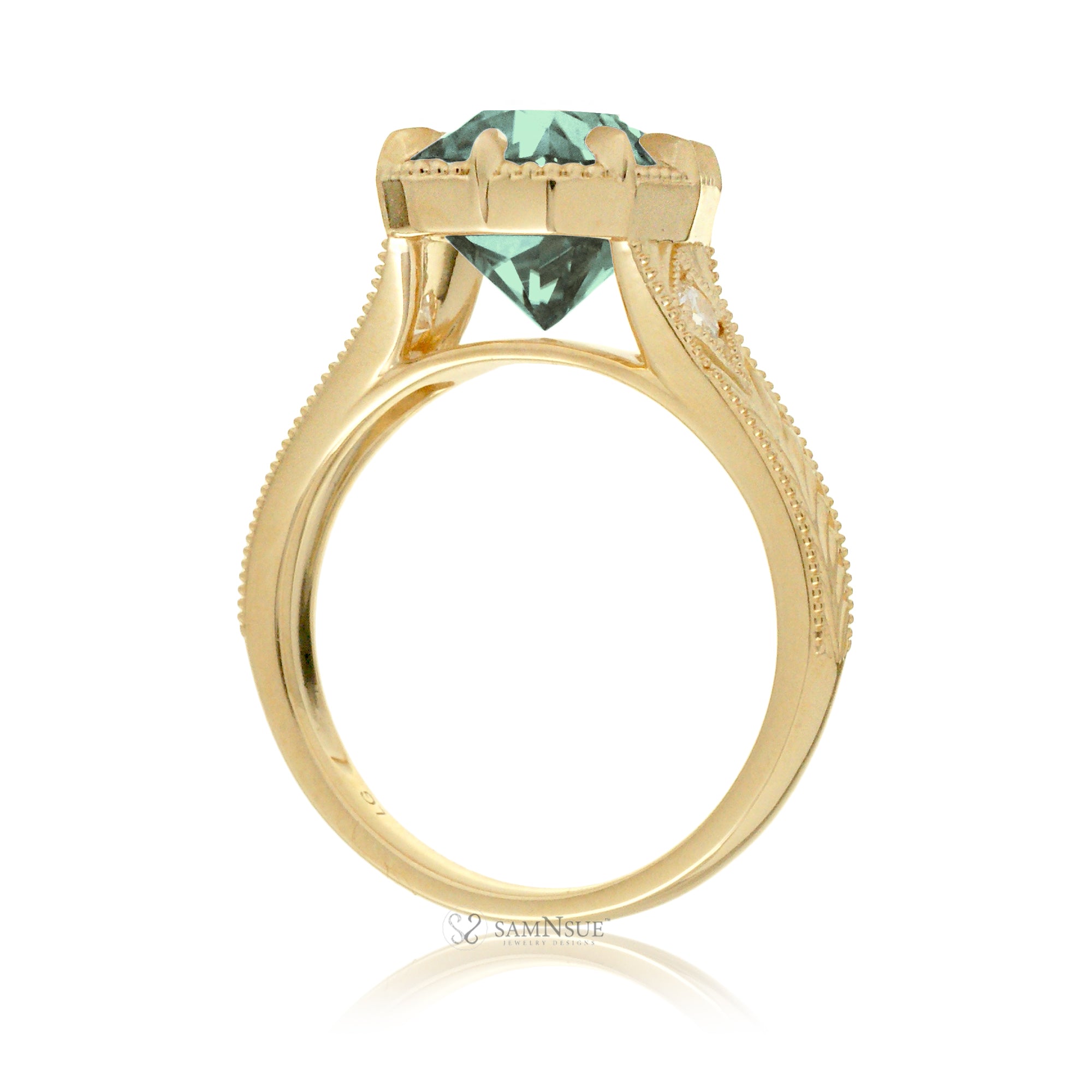 The Kelcey is a vintage-inspired green sapphire ring showcasing a cushion cut green sapphire, admired for its rich, vibrant green brilliance.