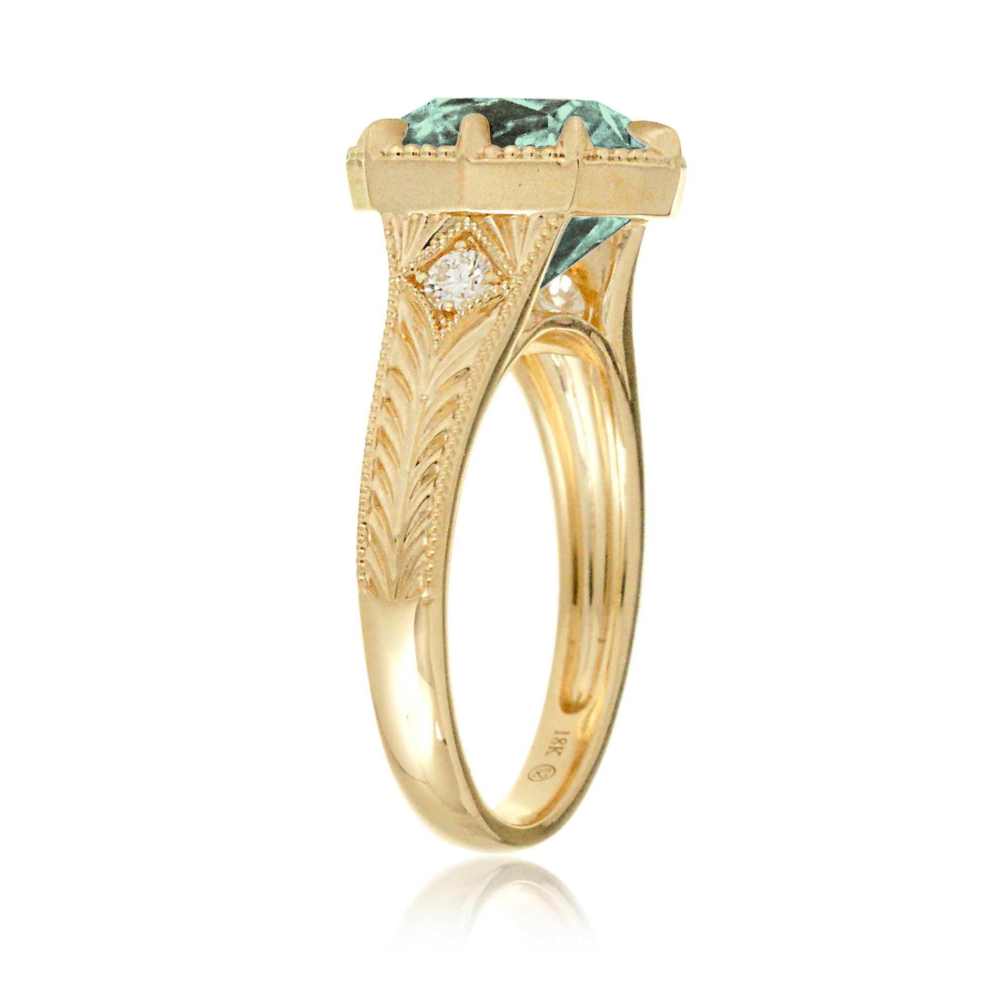 The Kelcey is a vintage-inspired green sapphire ring showcasing a cushion cut green sapphire, admired for its rich, vibrant green brilliance.