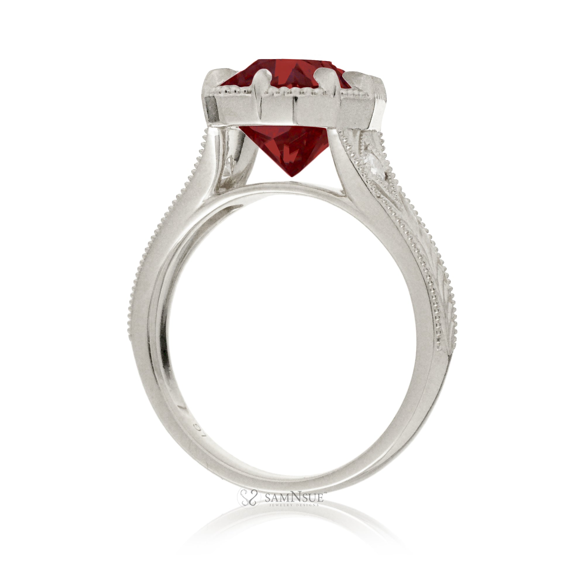 An elegant cushion cut ruby takes center stage in this vintage-style ring. The rich designed white gold band, adorned with delicate detailing, highlights the diamond’s fire and evokes a sense of classic, enduring romance.