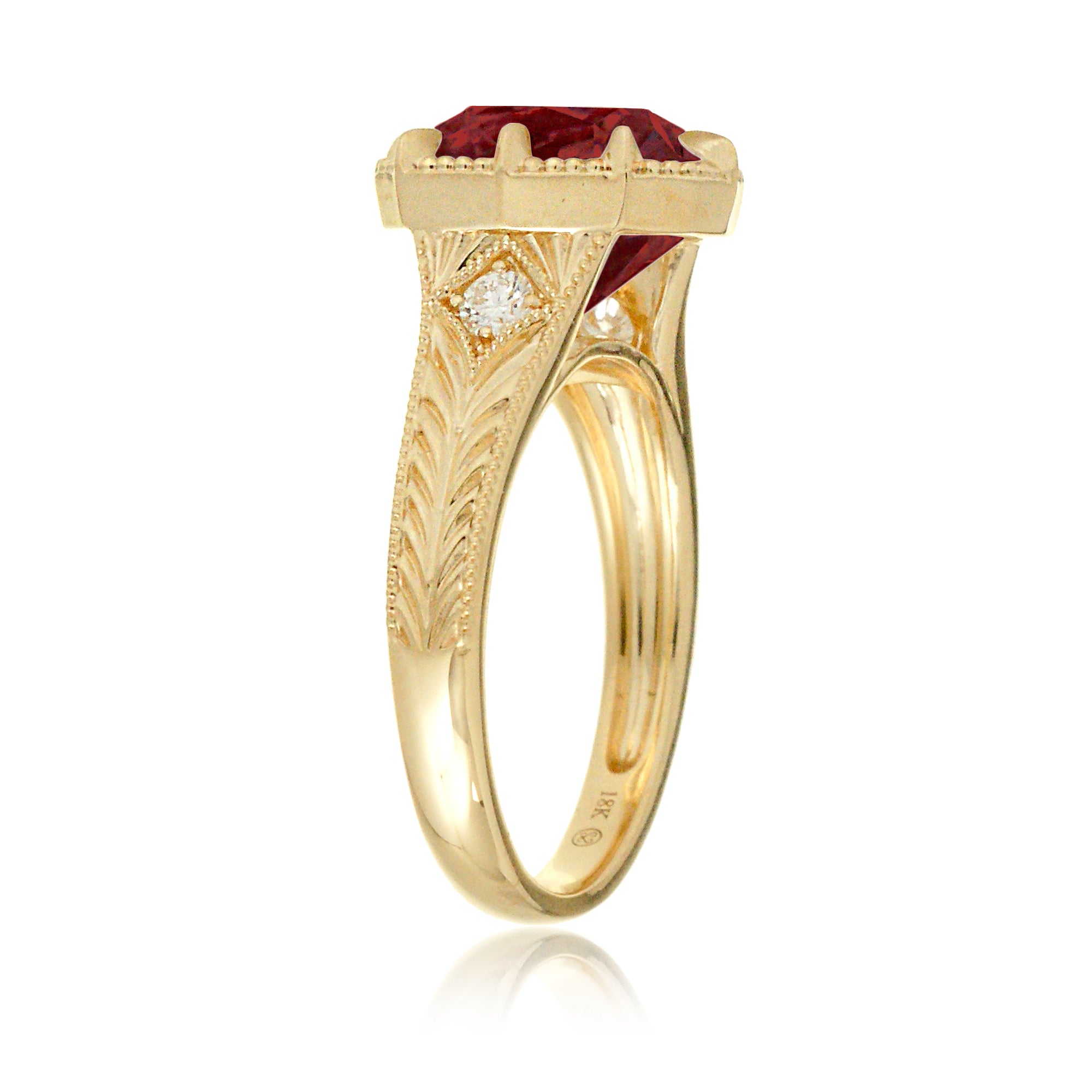 An elegant cushion cut ruby takes center stage in this vintage-style ring. The rich designed yellow gold band, adorned with delicate detailing, highlights the diamond’s fire and evokes a sense of classic, enduring romance.