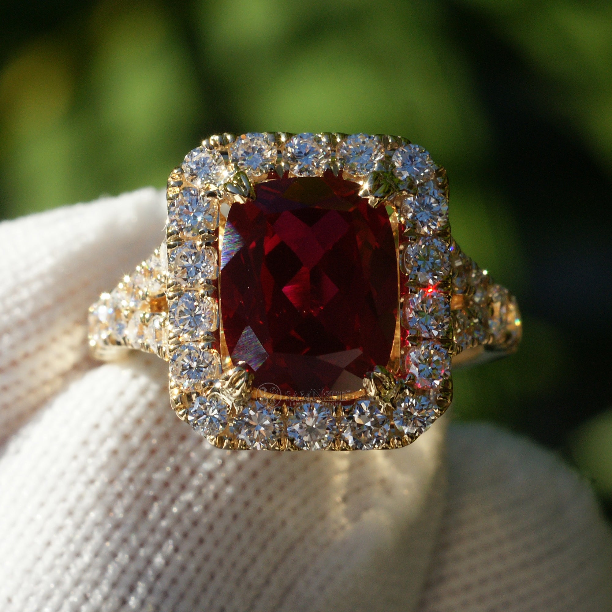 Cushion ruby with large diamond halo engagement ring with split band in yellow gold 10x8mm